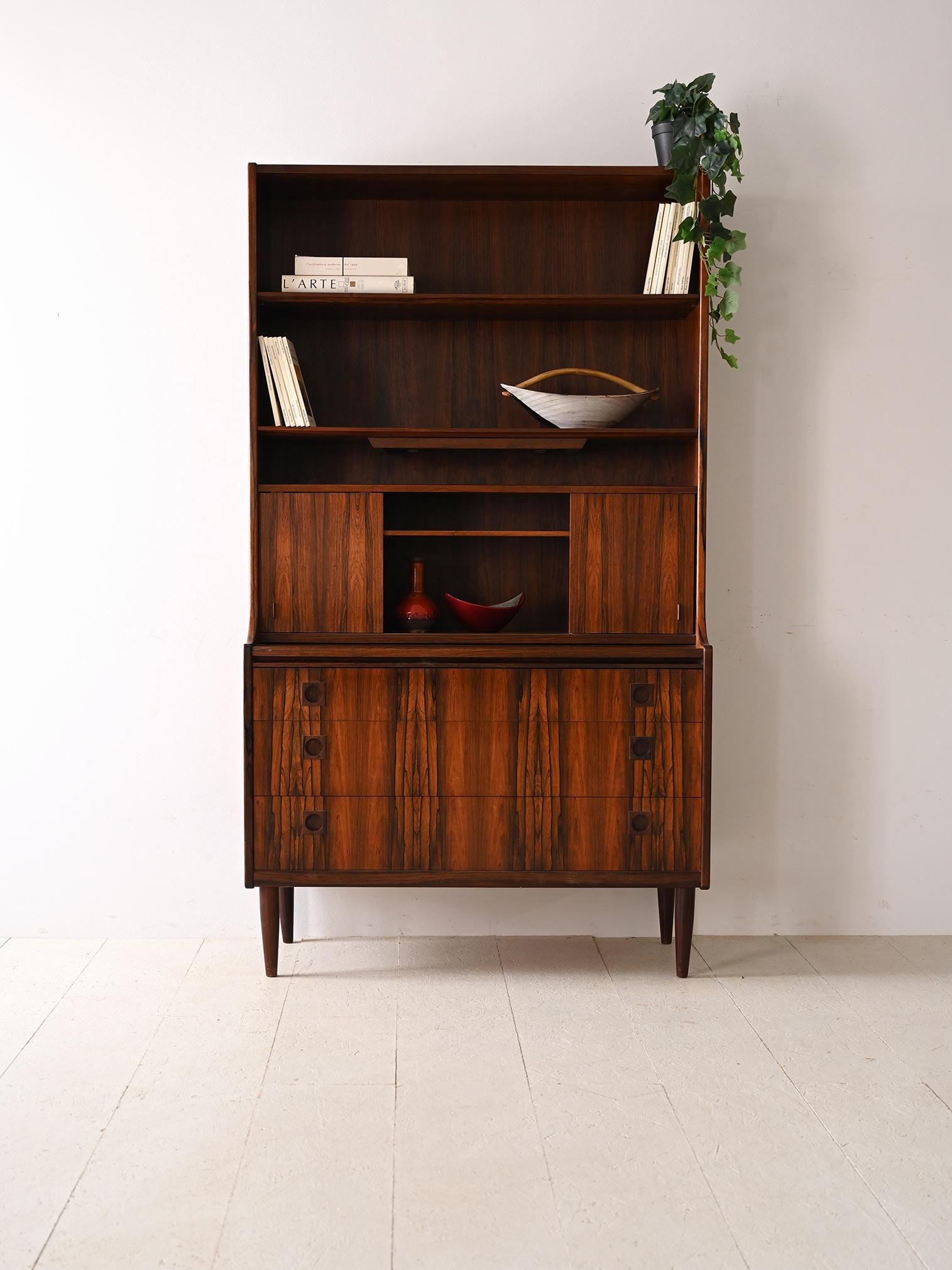 Vintage Scandinavian rosewood cabinet with built-in writing desk.

Made from fine rosewood, this piece of furniture embodies the natural beauty and durability that only high-quality materials can offer. 
The lower part of the cabinet houses three