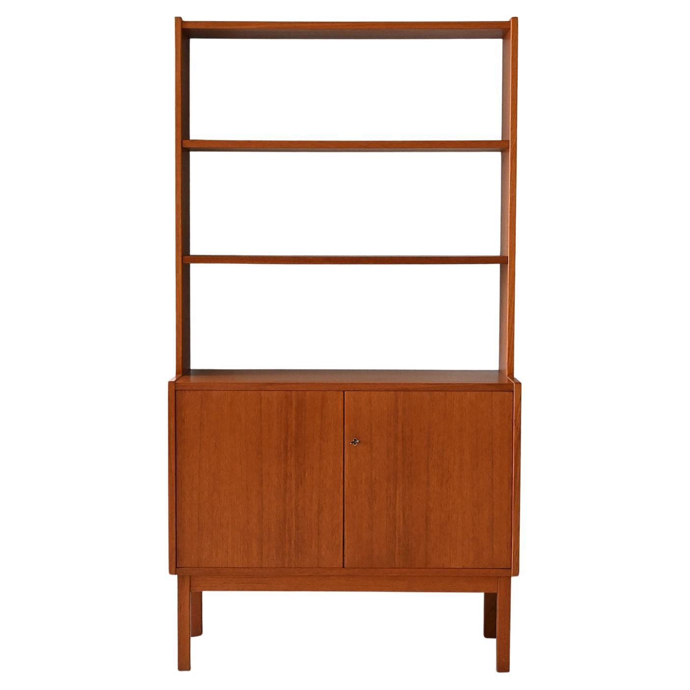 Vintage Scandinavian bookcase with hinged doors and exposed shelves