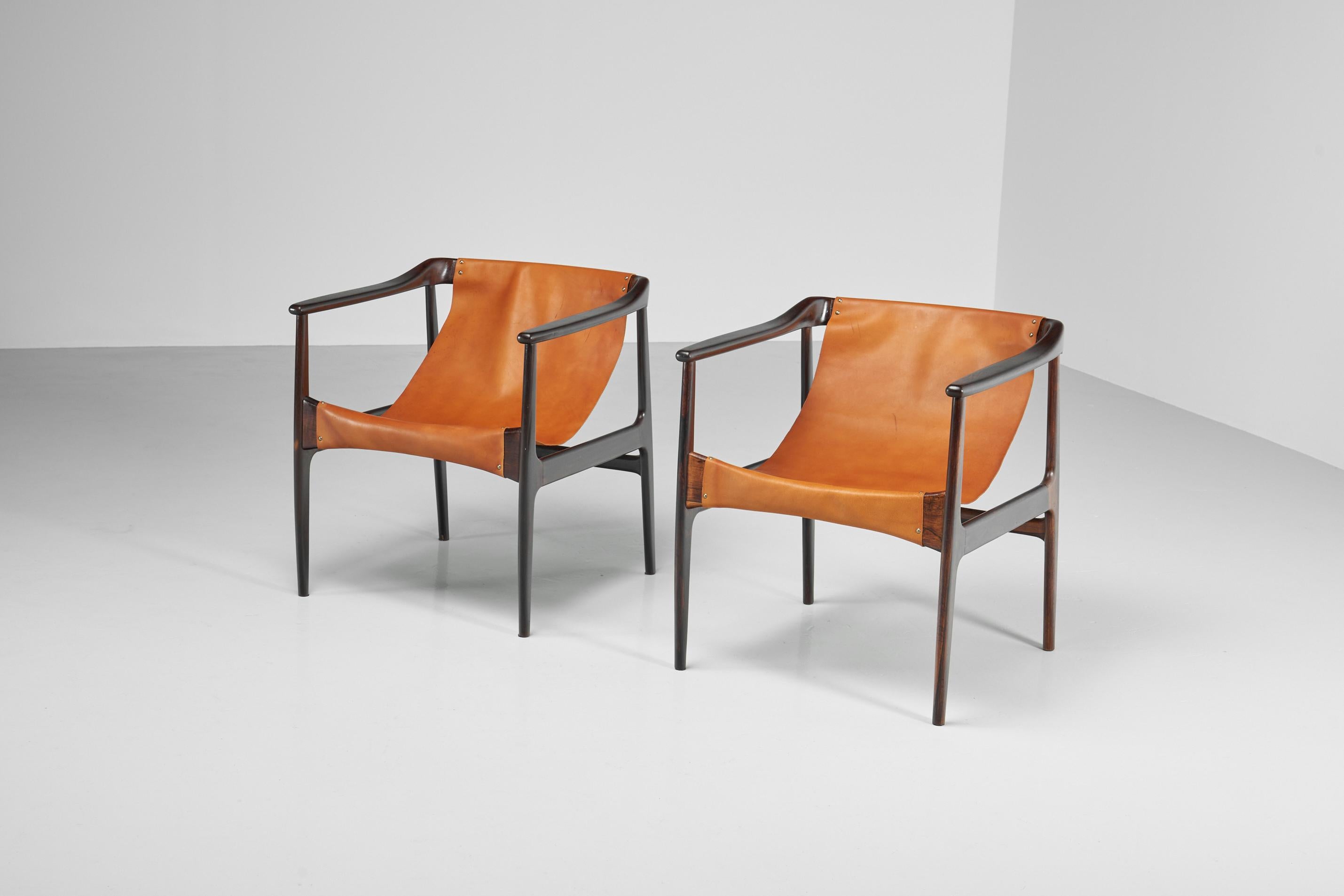 Striking pair of armchairs designed and made by Lice de Artes e Oficios, Brazil 1960. These lounge chairs made by Liceu de Artes e Officios have a beautiful patina and are in a very good, restored condition, no significant signs of heavy usage or