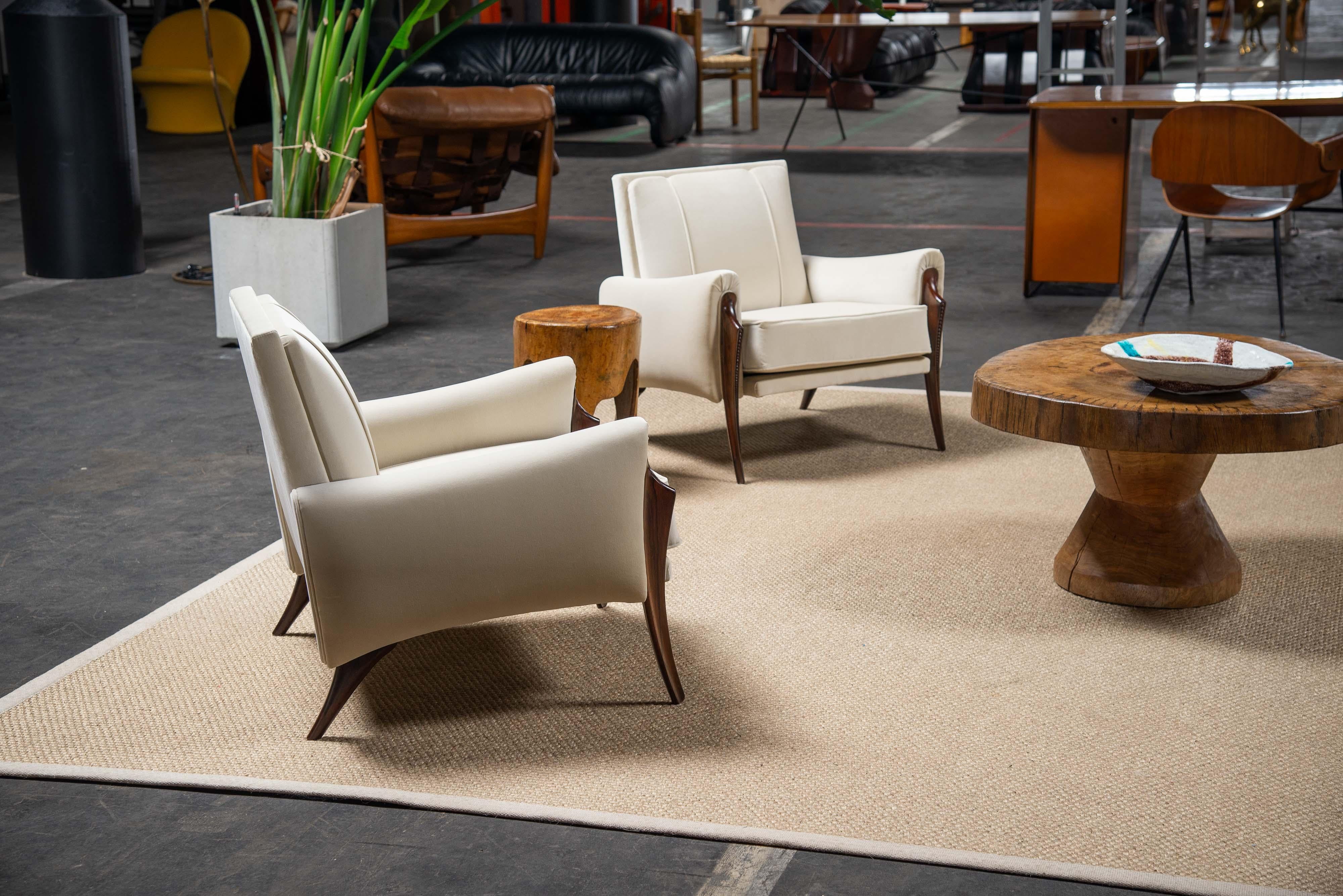 Super rare sculptural lounge chairs designed and made by Liceu de Artes e Oficios, Brazil 1955. The chairs have elegant lines and awesome woodworking details. The feet are slightly angled and made of solid rosewood showing off a fantastic grain and