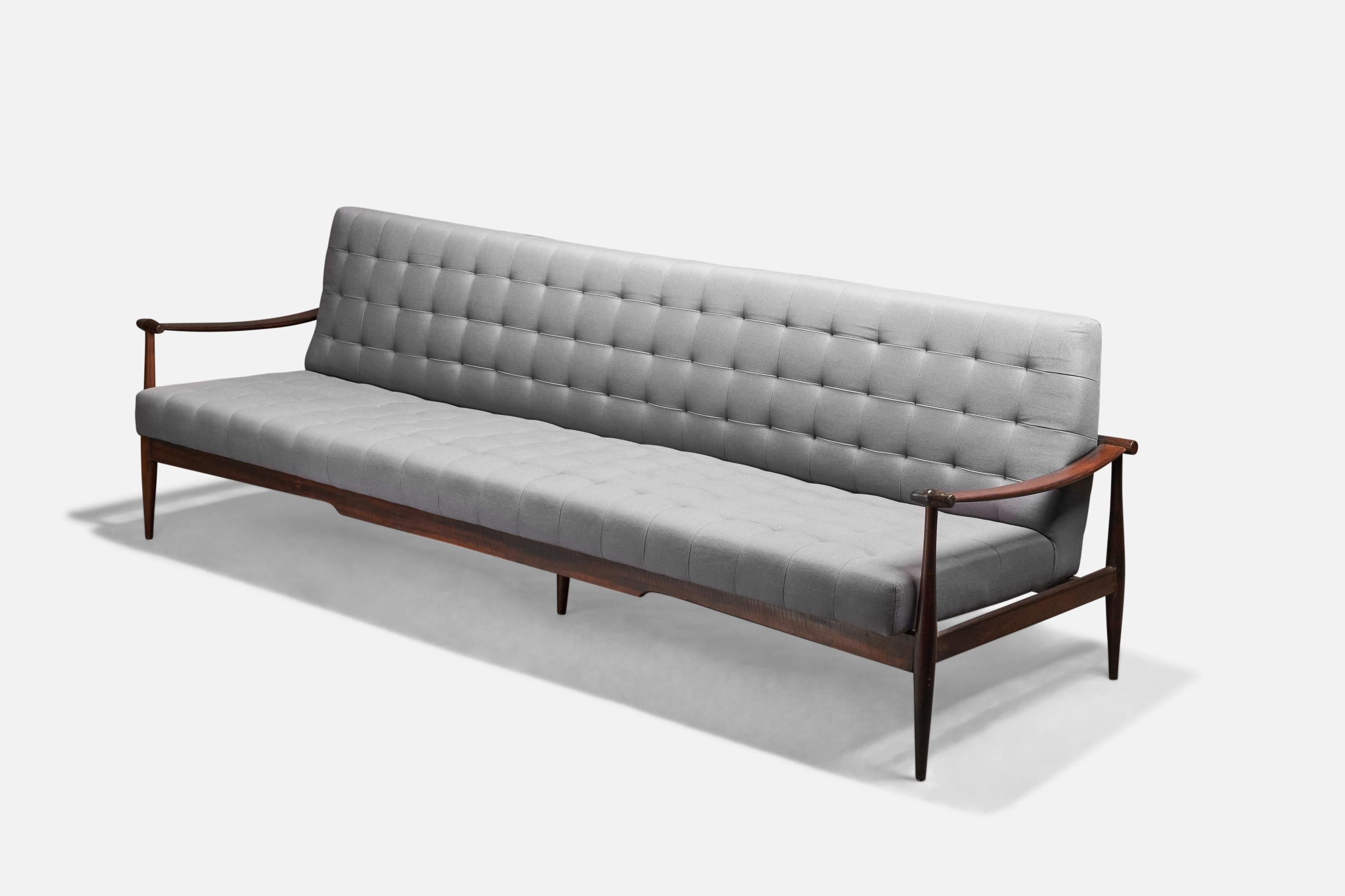 A grey fabric and rosewood sofa designed and produced by Liceu de Artes e Ofícios, Brazil, 1955.

Presents with partial makers label to underside.