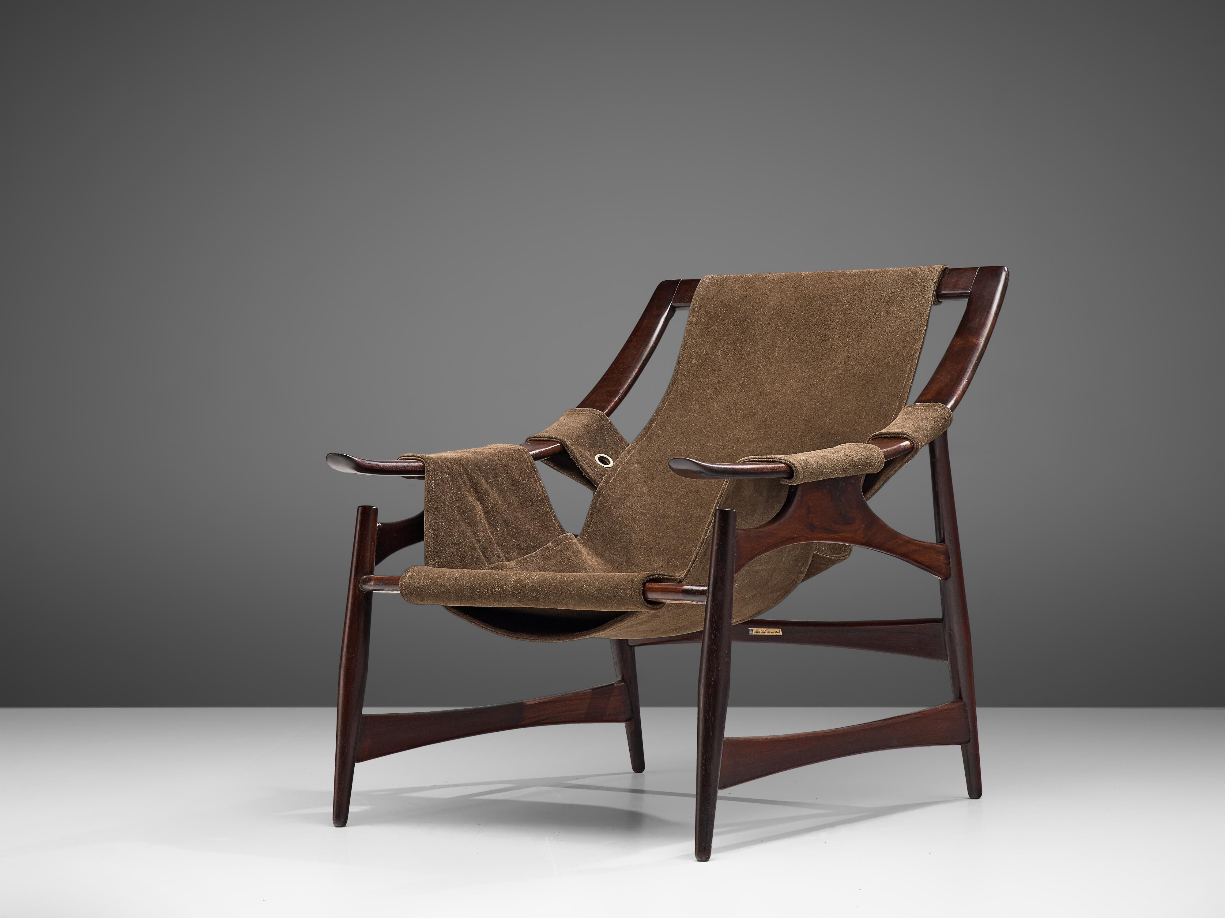 Liceu de Artes e Ofi´cios, lounge chair, imbuia and suede, Brazil, 1960s. 

Beautiful lounge chair in dark imbuia with a brown suede upholstery. The construction of the frame is created according to a skeleton layout. The design holds an open