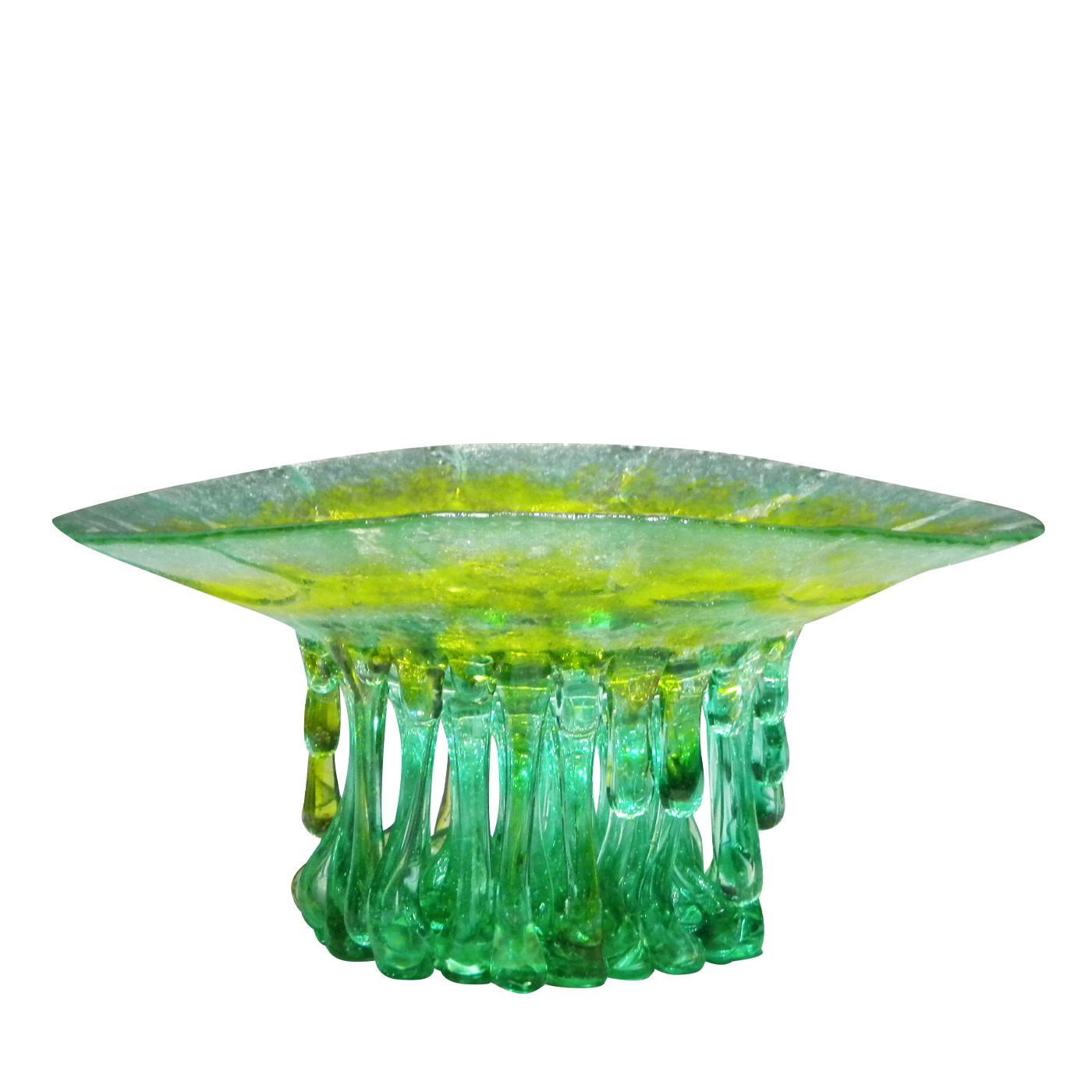 Green and yellow hues blend in this beautiful sculpture that conjures up a jellyfish, what with its smooth top and multitude of green drip shapes underneath. This piece is crafted exclusively from Murano glass and lets light filter onto surfaces on