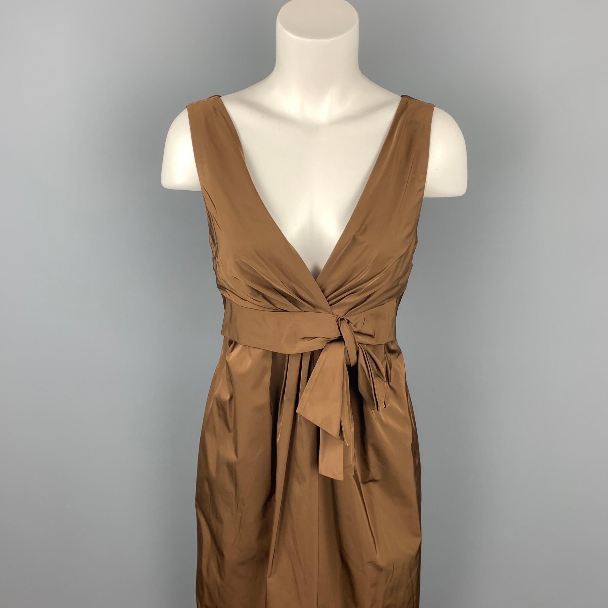 LIDA BADAY dress comes in a brown polyester with a slip liner featuring a sheath style, front bow, and a back zip up closure.

Good Pre-Owned Condition.
Marked: 8

Measurements:

Shoulder: 14.5 in. 
Bust: 32 in. 
Waist: 30 in. 
Hip: 38 in. 
Length: