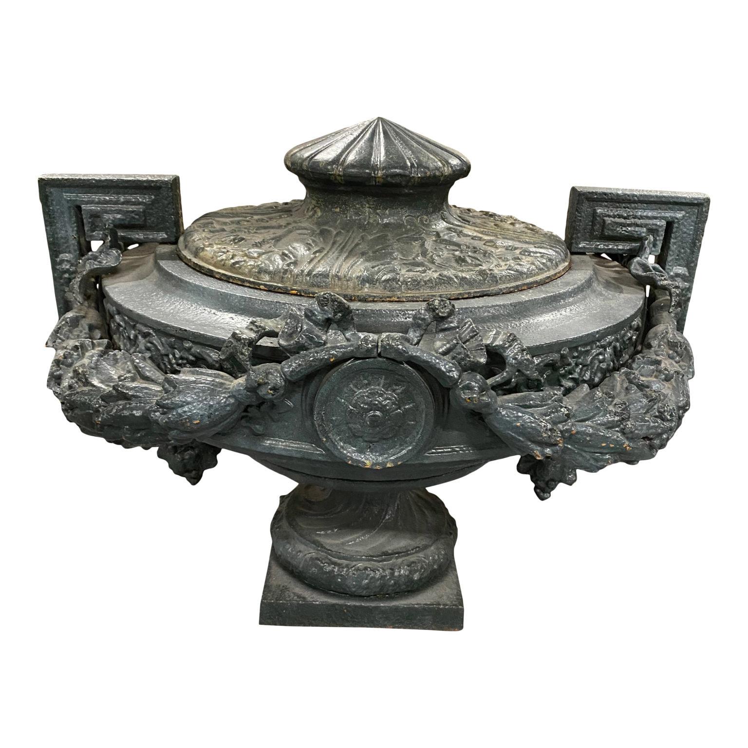 Rare 19th century cast iron green urn with large garlands around rim, greek key handles, and lid

19 H, 25 OAD, 8.25? Square Base.

.