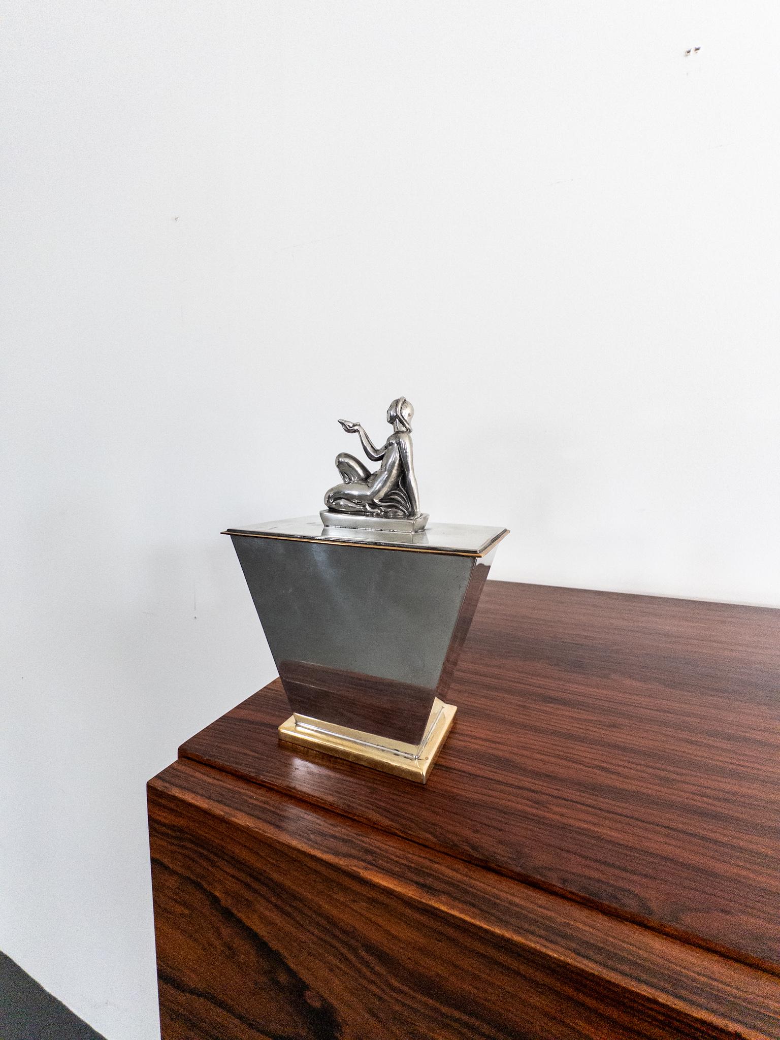 This exquisite lidded box from Ystad Metall, designed by the renowned Swedish sculptor Oscar Antonsson, is a true Art Deco masterpiece from the 1930s. Crafted in high-quality pewter (tin) with elegant brass details, it features a striking geometric