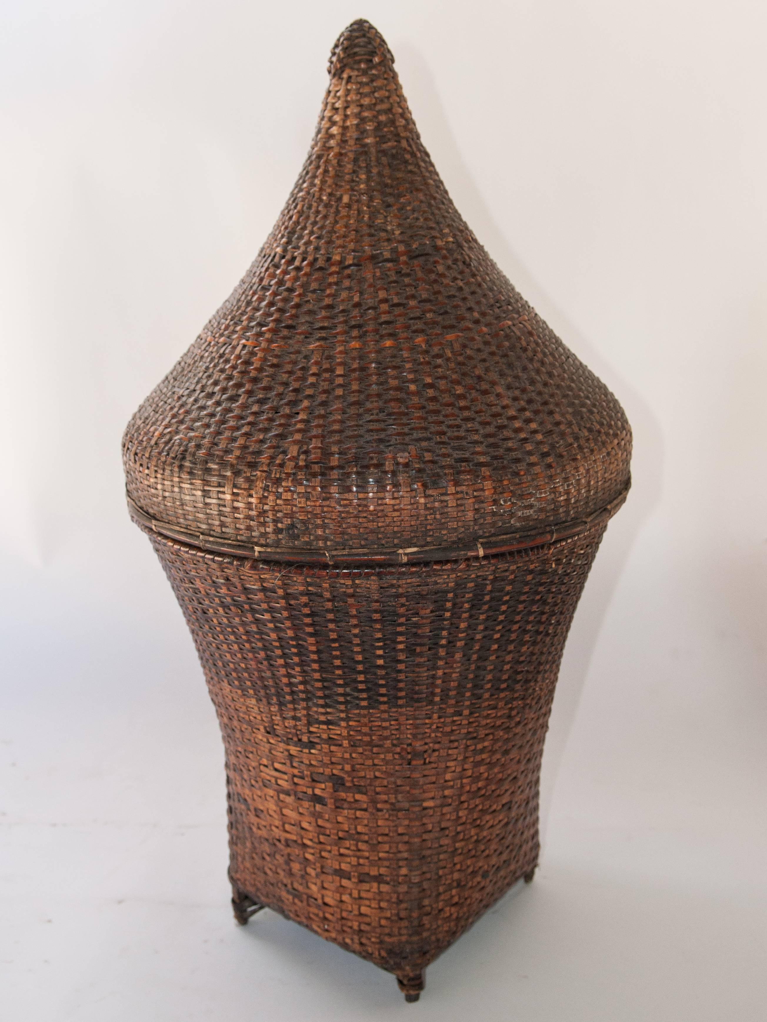 Lidded handwoven storage basket. Chin people of Burma, mid-20th century, bamboo.
Offered by Bruce Hughes.
This footed basket would have been used to transport and store household items - textiles and other valuables. It comes from the Chin or
