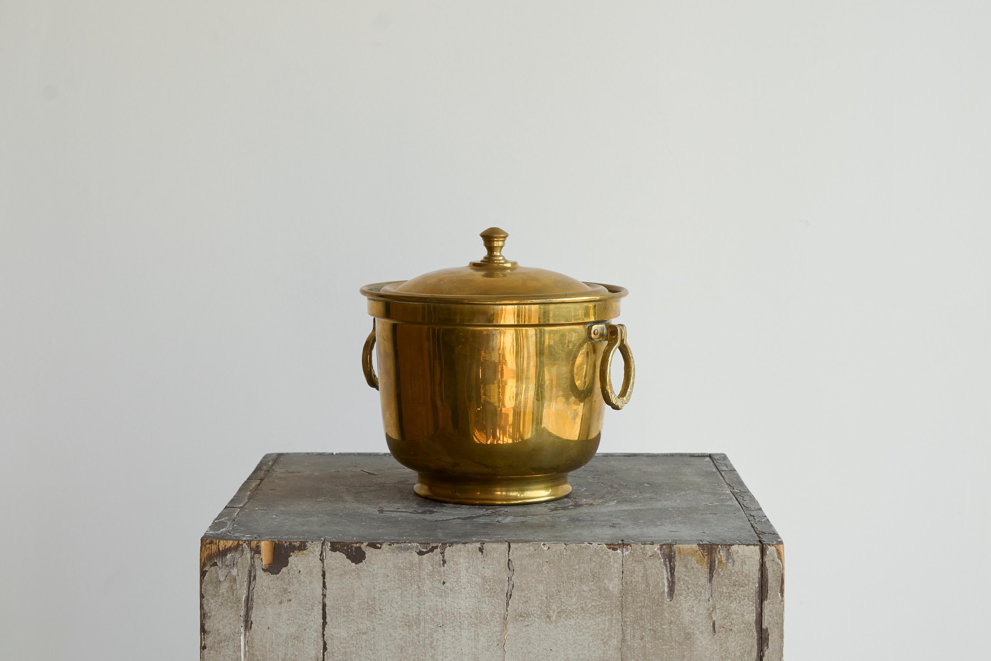 Lidded Ice Bucket in Patinated Brass by Nader 1950s.

Wonderful early to mid 20th century ice bucket with lid made by the renowned Nader factory in Tehran, Iran. Great design with wonderful handles, a timeless base shape and a fantastic patina.