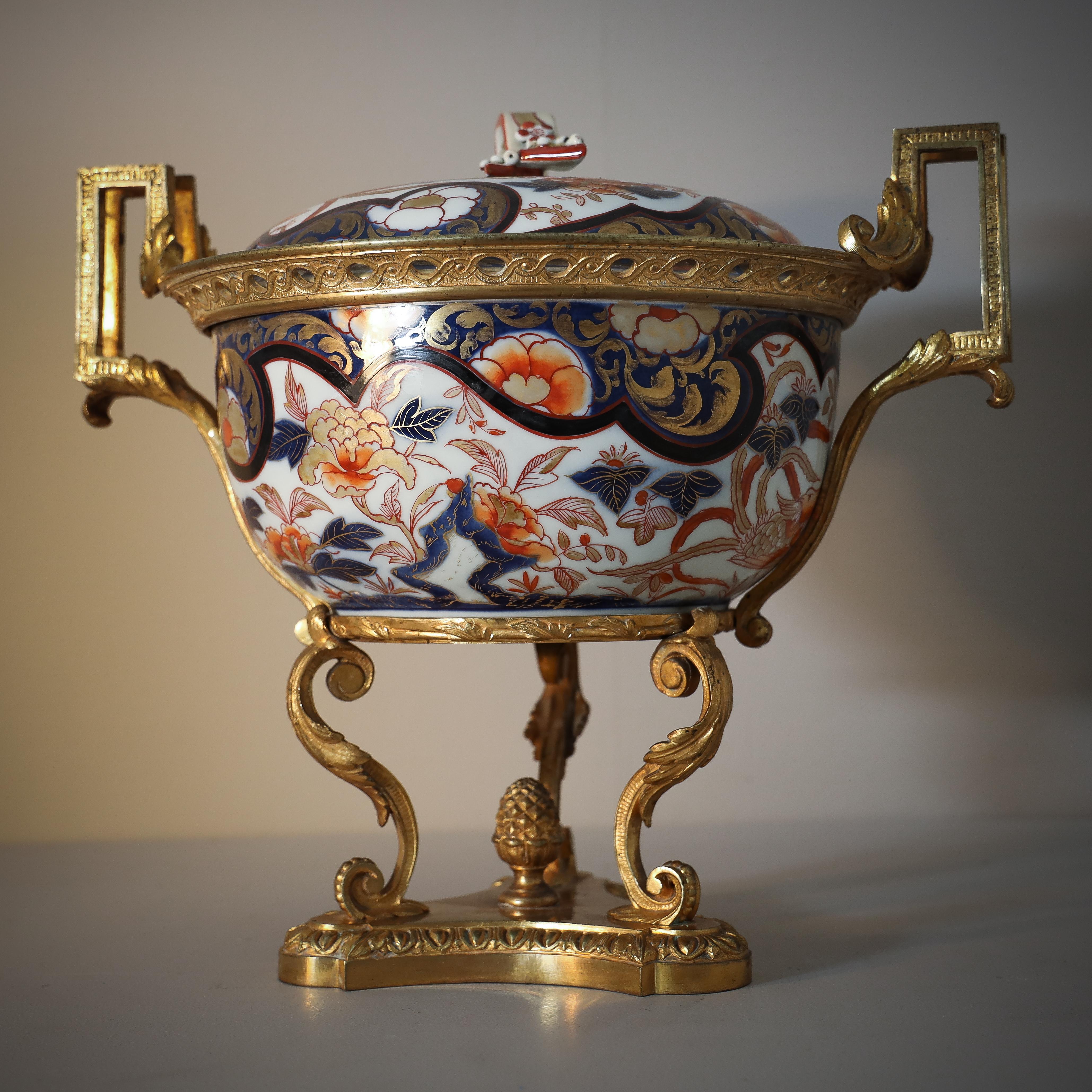 Large porcelain lidded vessel with gilt brass mounts and stand.

 