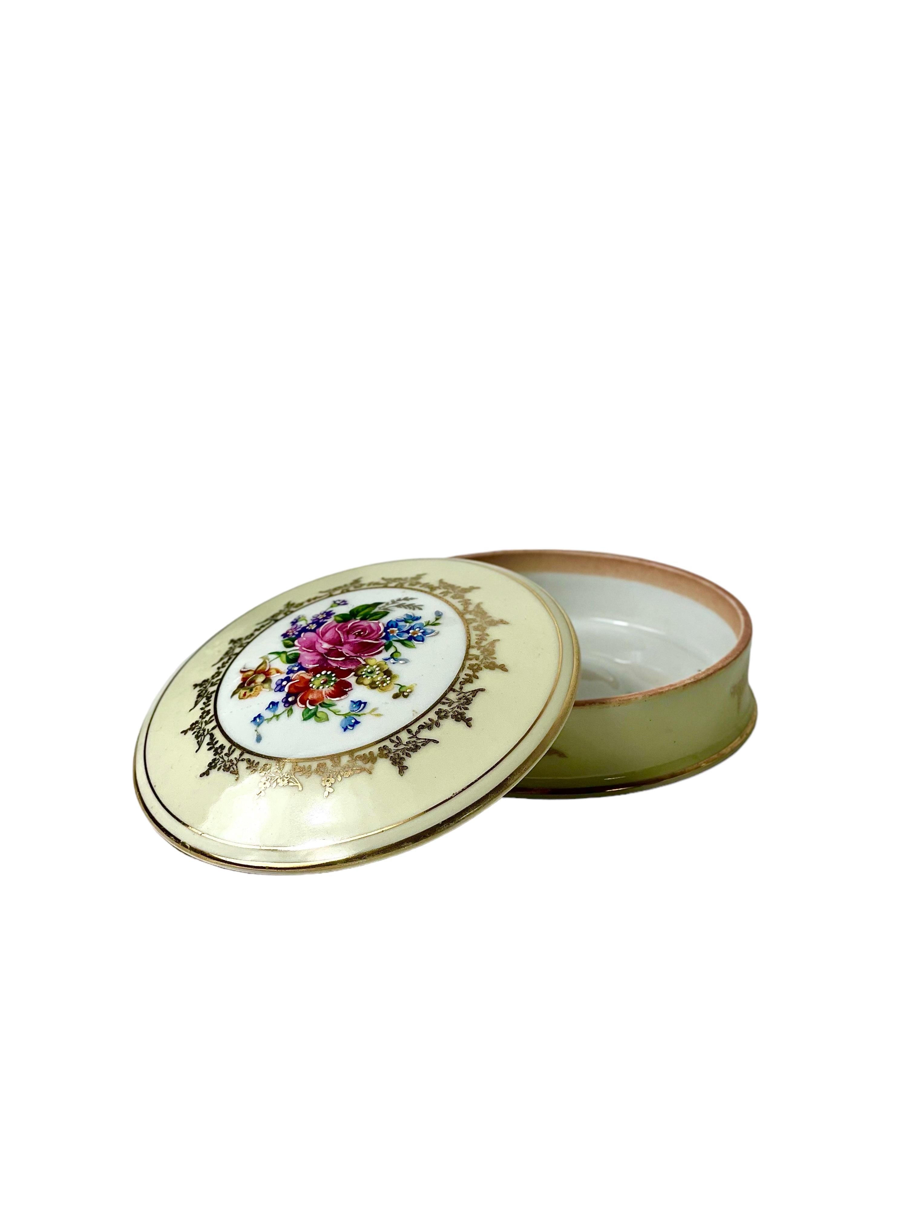 Beautiful Limoges porcelain hand-crafted and hand-painted, gold-rimmed trinket, jewellery box or lidded sweets dish. 
Glazed throughout in a creamy ivory, the lid of the dish features a startlingly vivid bouquet of wildflowers and foliage, enclosed