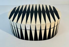 Lidded Oval Box with a distinct black and white bone inlay geometric pattern