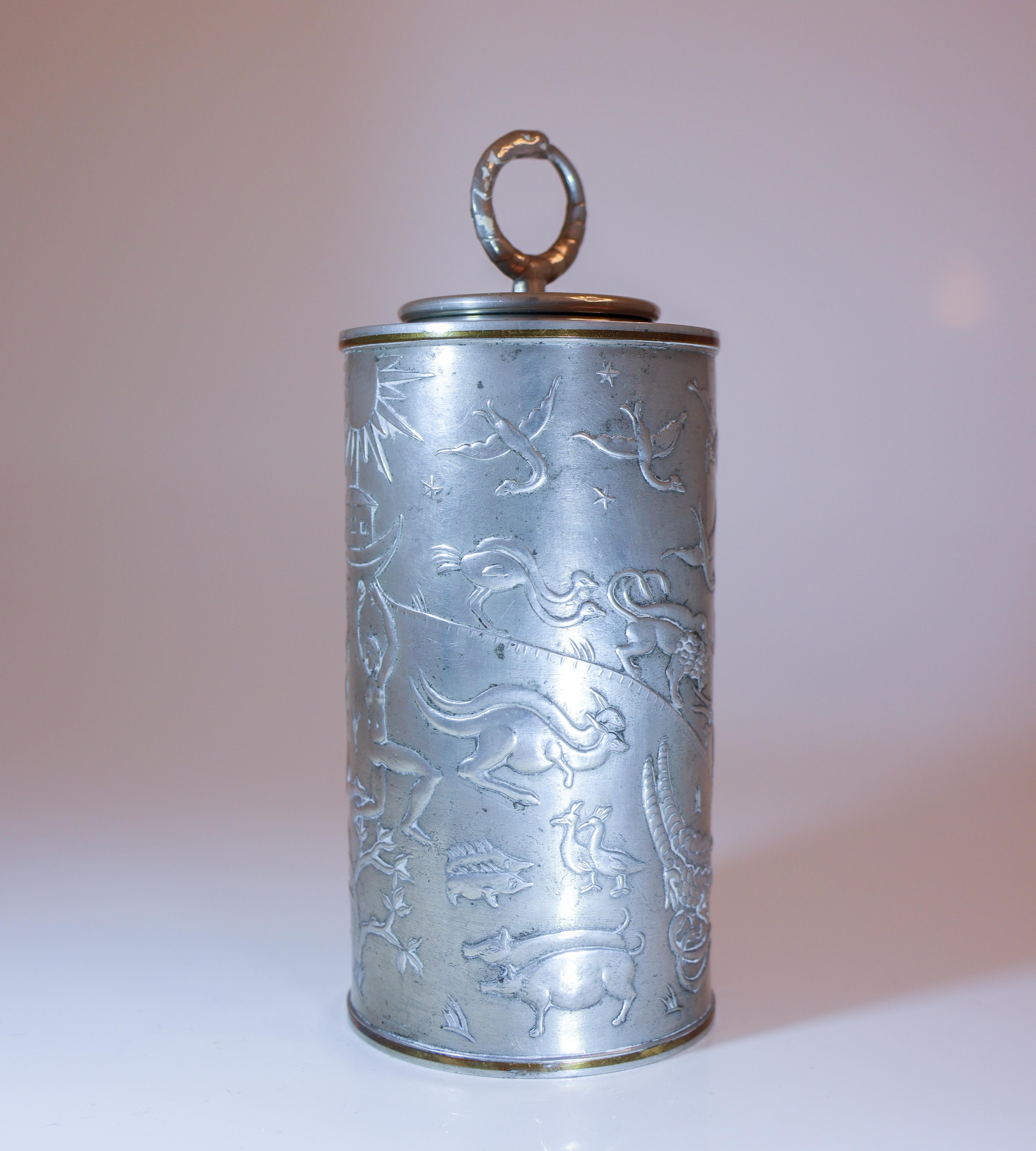 A wonderful lidded jar designed by Nils Fougstedt for Firma Svenskt Tenn in Stockholm and made in 1931. The jar features scenes from the Garden of Eden, Adam and Eve, and the animals from Noah’s Ark. The lid has a pull ring shaped like the