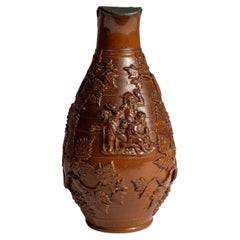 Lidded Stoneware Jug With Raised Grape Vine Decoration