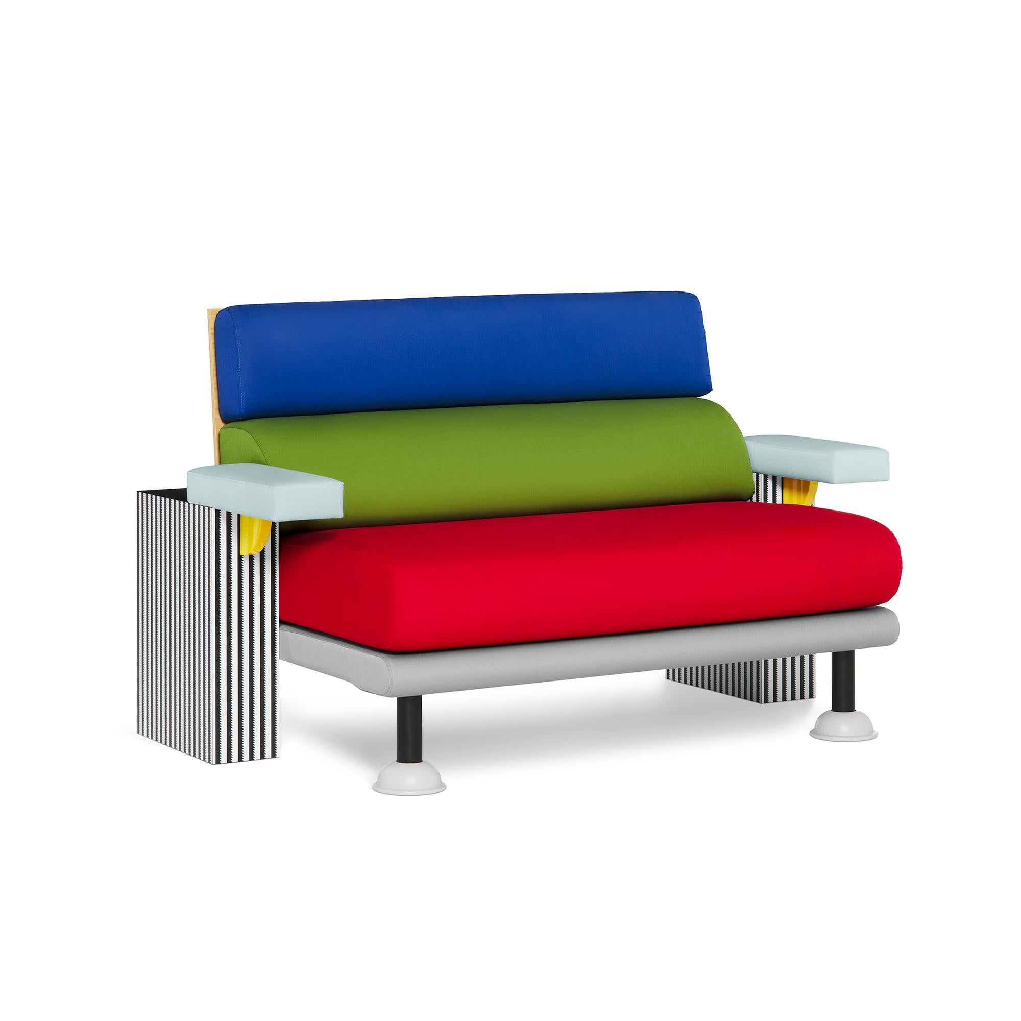 Wooden sofa covered with decorative laminate, metal elements, fabric upholstery.

Lido, a sofa created in 1982 by Michele De Lucchi, is eccentric and elegant at the same time. The juxtaposition of forms and volumes plays with the combination of