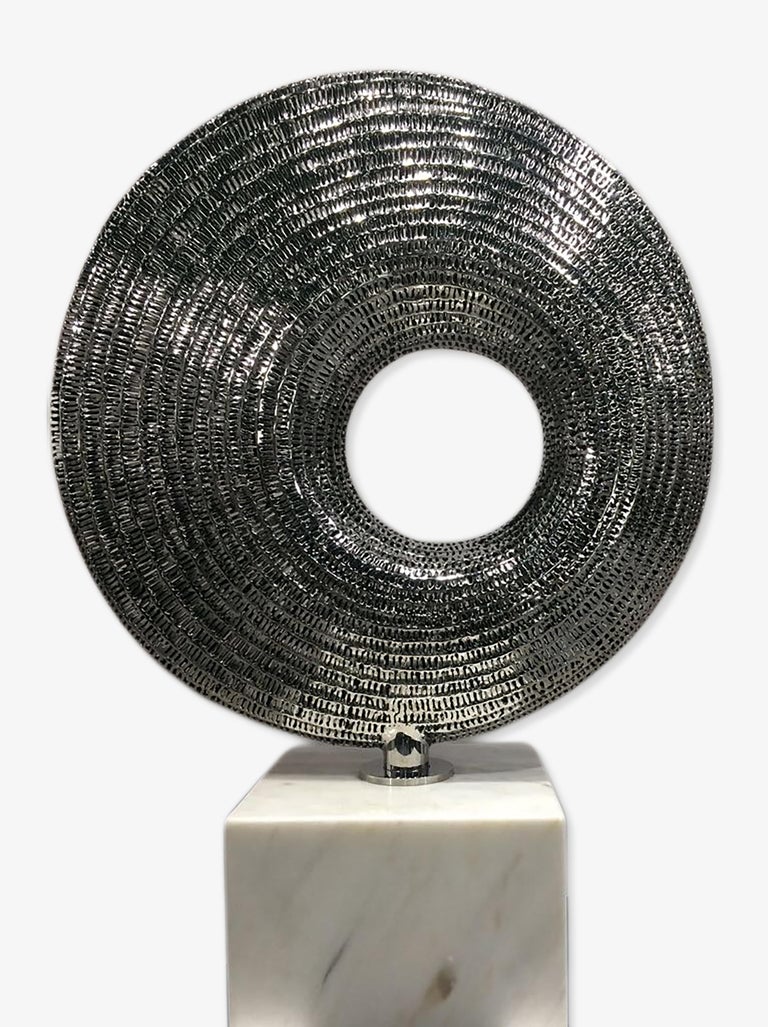 Stainless steel sculpture with marble base.

Liechennay's works are inspired by nature and life, simply put, the forms and shapes he is surrounded by. He creates highly aesthetic pieces embodying artistic balance and beauty that transmit a sense of