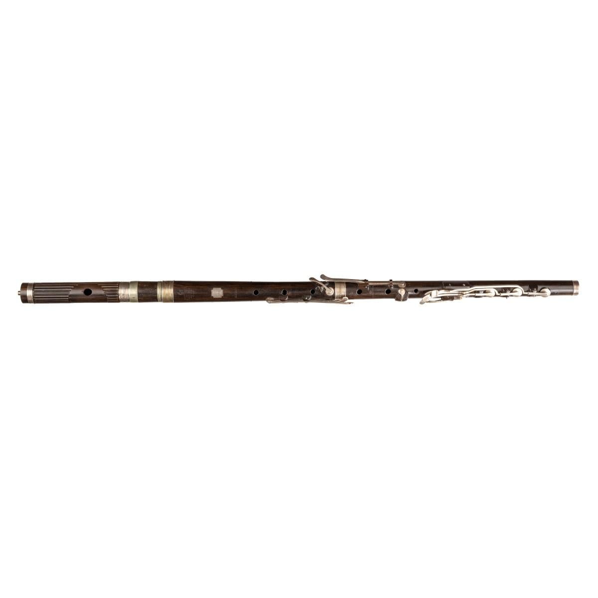 This rare George IV silver mounted crocus-wood flute was made by Monzani & Co for George William Rabett. It is fitted within a purpose made seagoing Campaign box with an applied brass plaque engraved with the coat of arms, crest and motto of Geo: Wm
