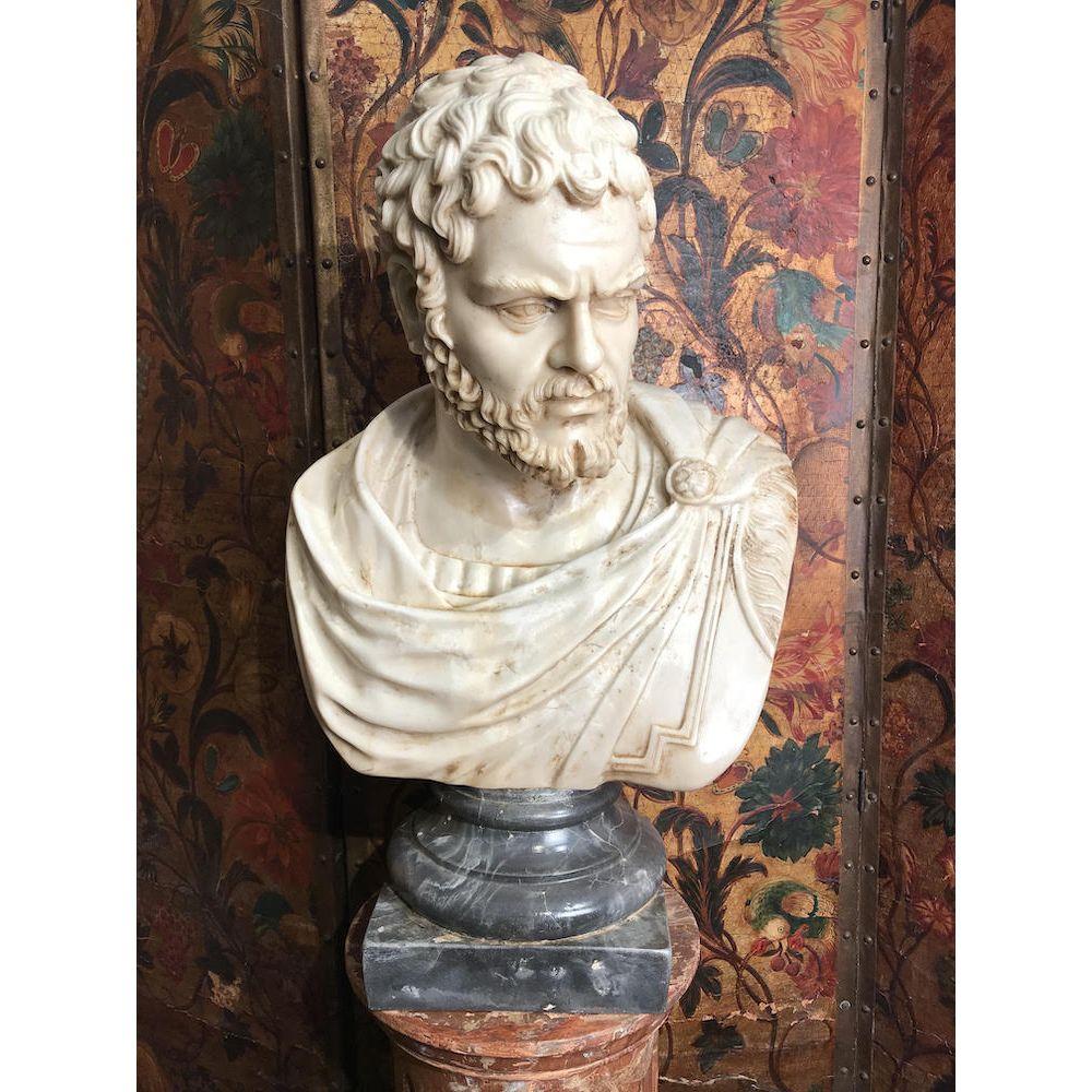 A dynamic, life-sized marble bust of a Roman in a toga with a leopard’s head clasp, raised on a variegated grey socle.
Mid-19th century.
This impressive antique bust of an - as yet to be identified - Roman, is in good condition. Some tentative