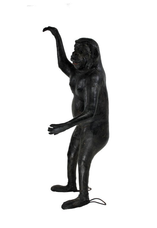 A French freestanding life-size figure of a monkey fashioned out of leather with green glass eyes. Some old repairs.
   
