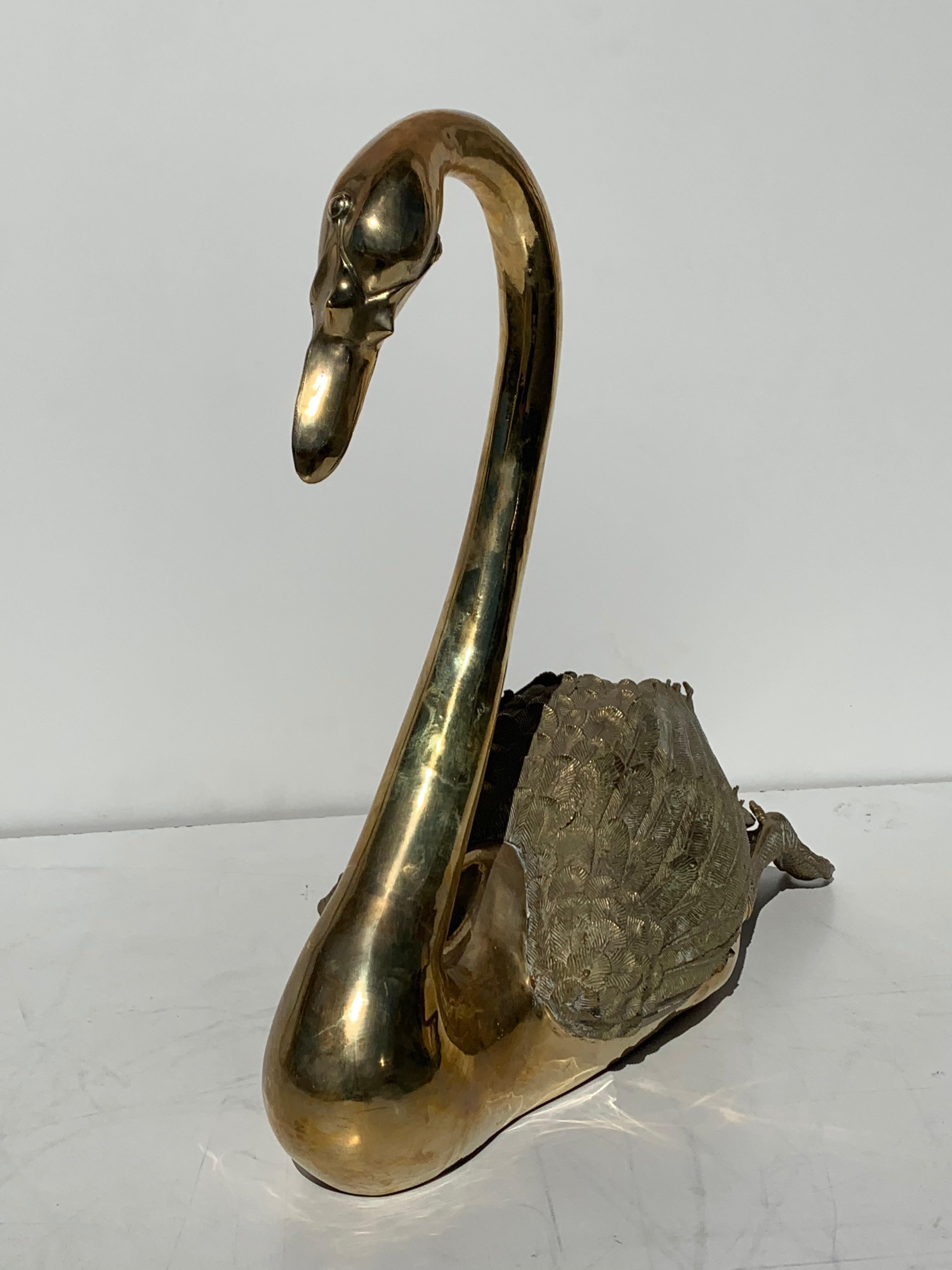 life-size brass swan sculpture.