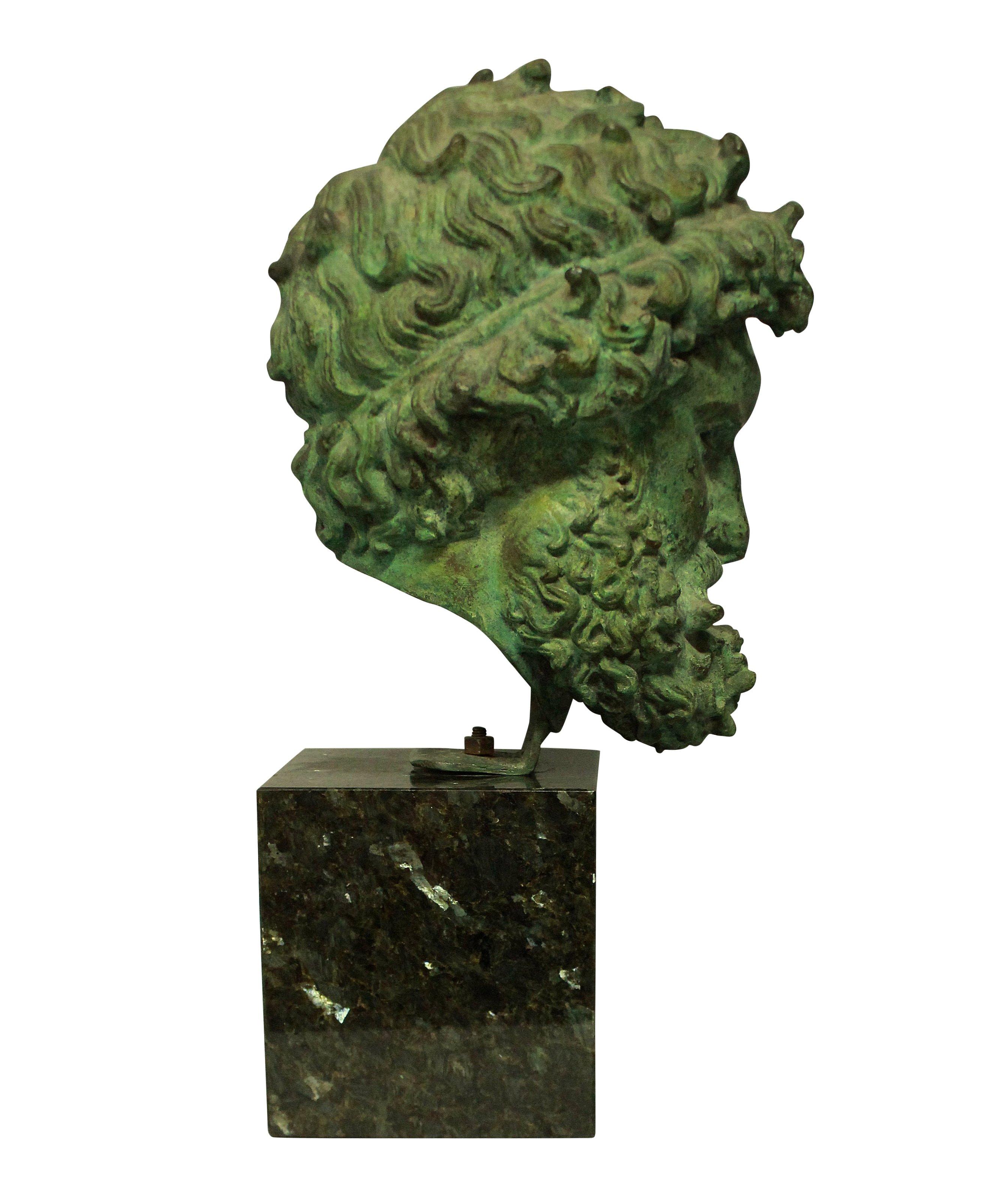 An Italian, finely cast bronze head of Zeus with good patination, mounted upon a marble base.