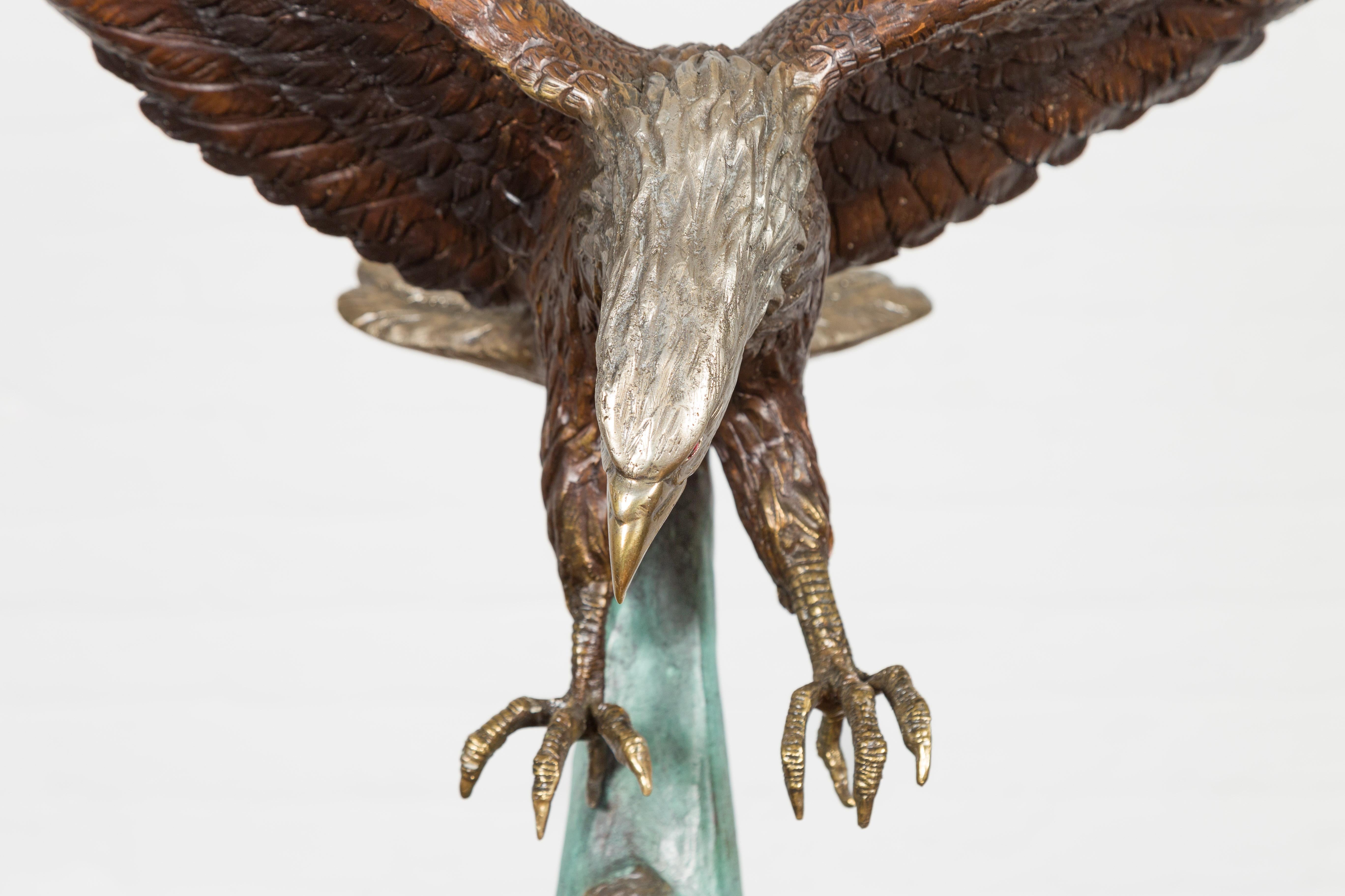 Sculpture en bronze grandeur nature d'un aigle en train de manger sur socle en marbre noir en vente 11