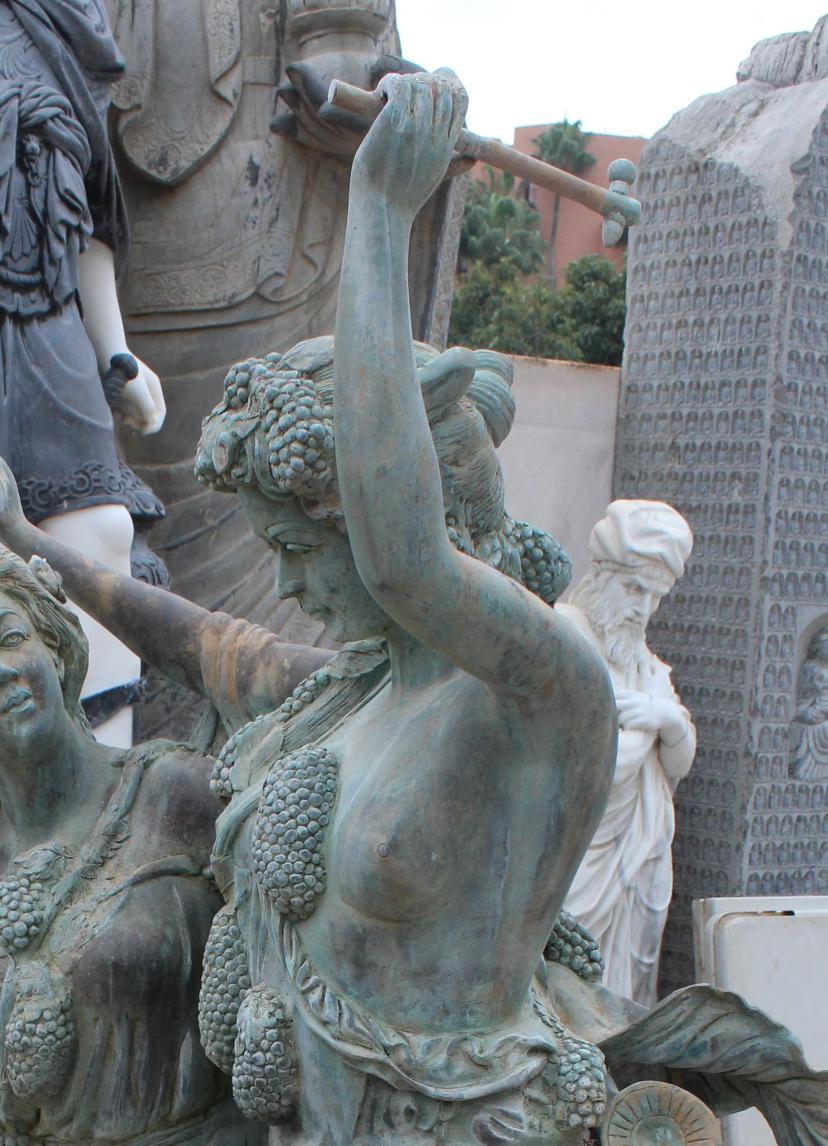 Life-size bronze sculptures of two ladies and a cherub, where grapes, a symbol for autumn, dominates the piece along with vegetative motifs. 

