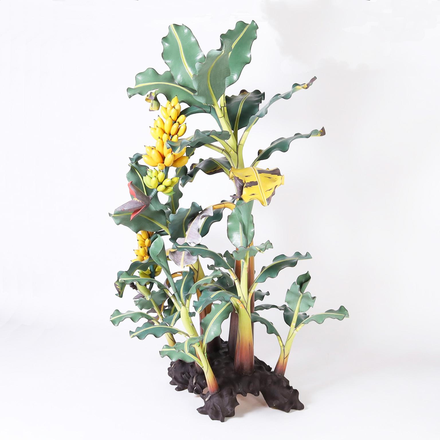Rare and remarkable life size Indonesian banana tree sculpture ambitiously crafted in wood and painted with eye catching realism. Detachable leaves and fruit for easy shipping.  
 