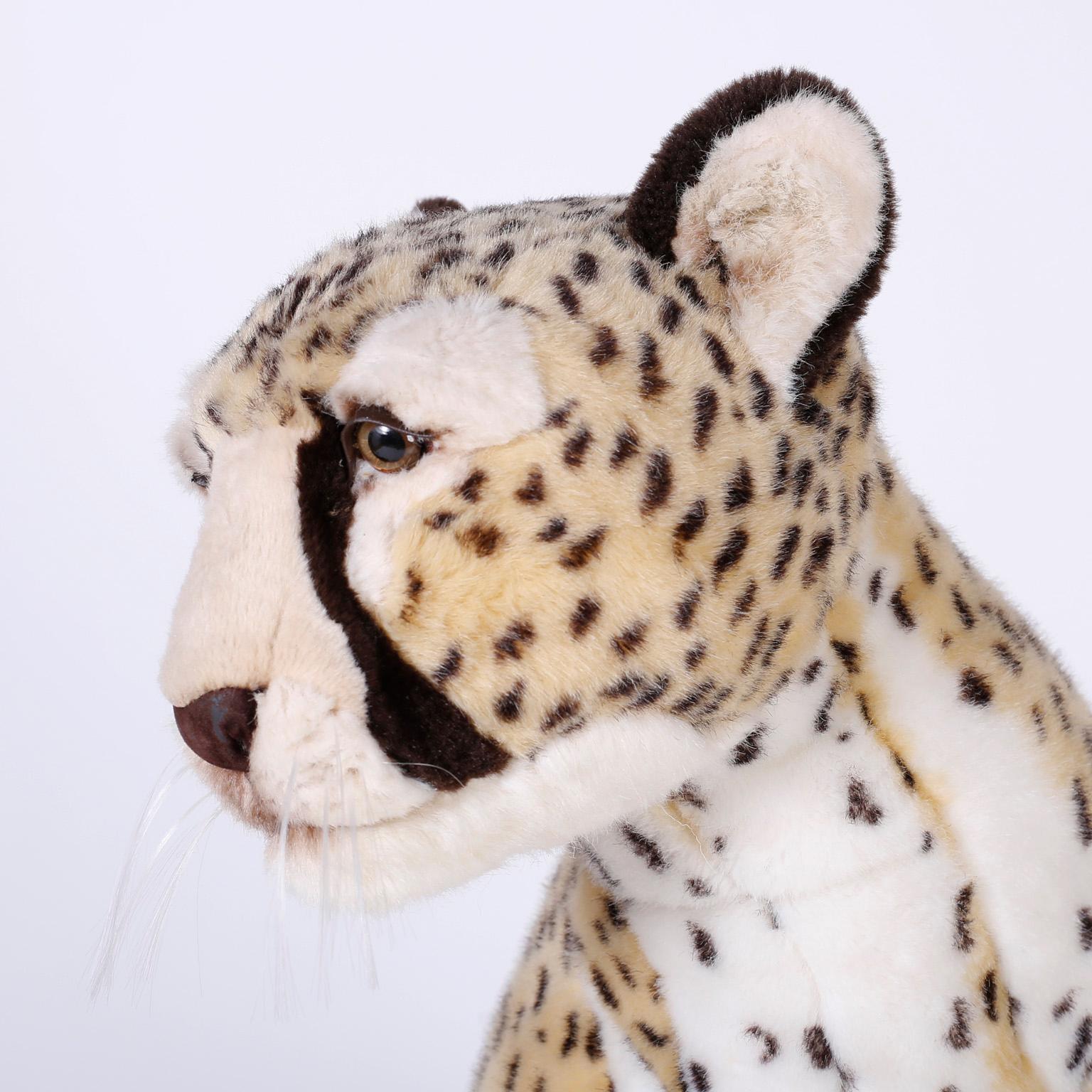 Striking handmade cheetah stuffed animal covered in plush jacquard fabric with distinctive realistic markings, glass eyes, whiskers and an intriguing life like size and stature.