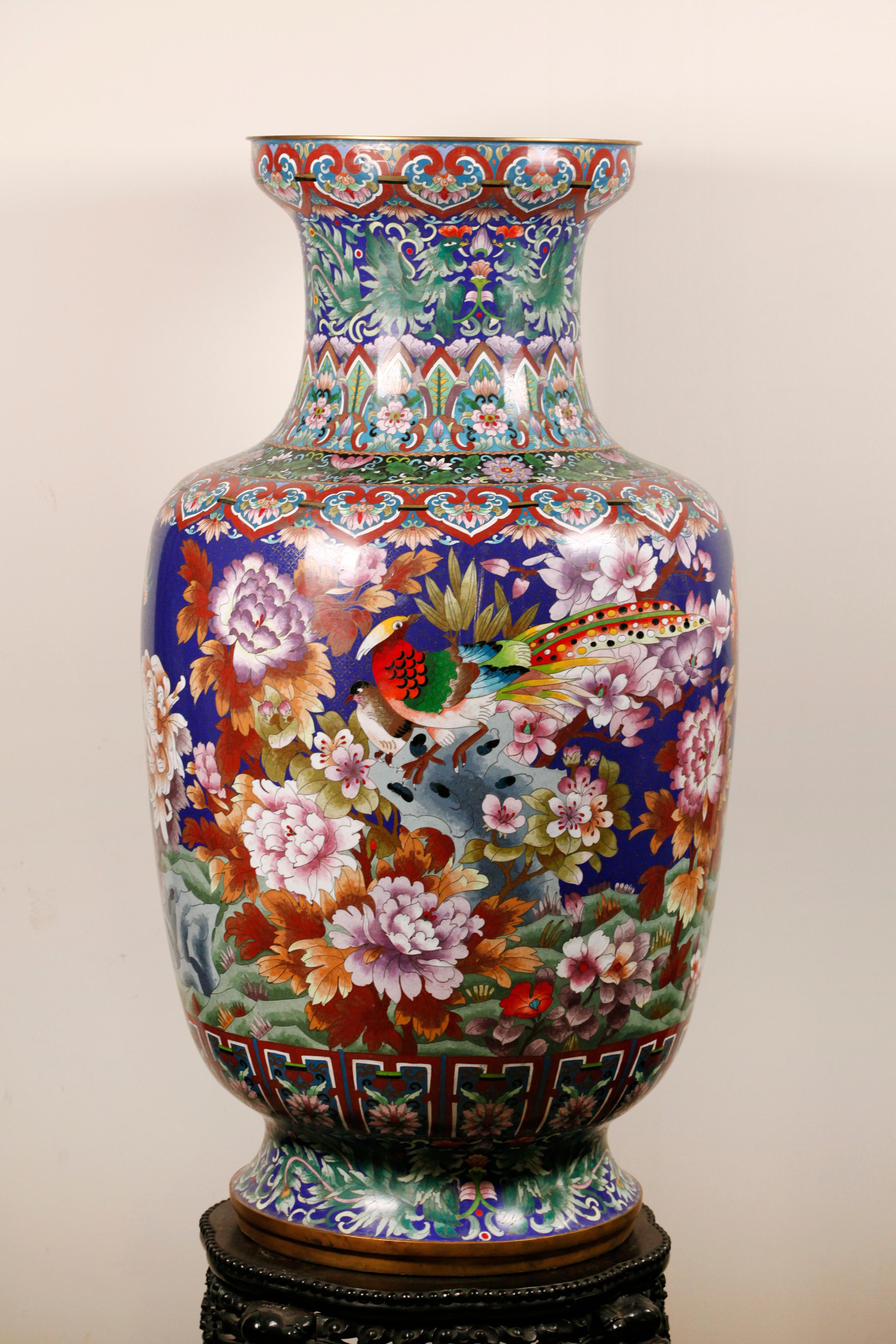 wooden stand/base shown in photographs is not included with this vase; vase decorated with multicolor floral motif