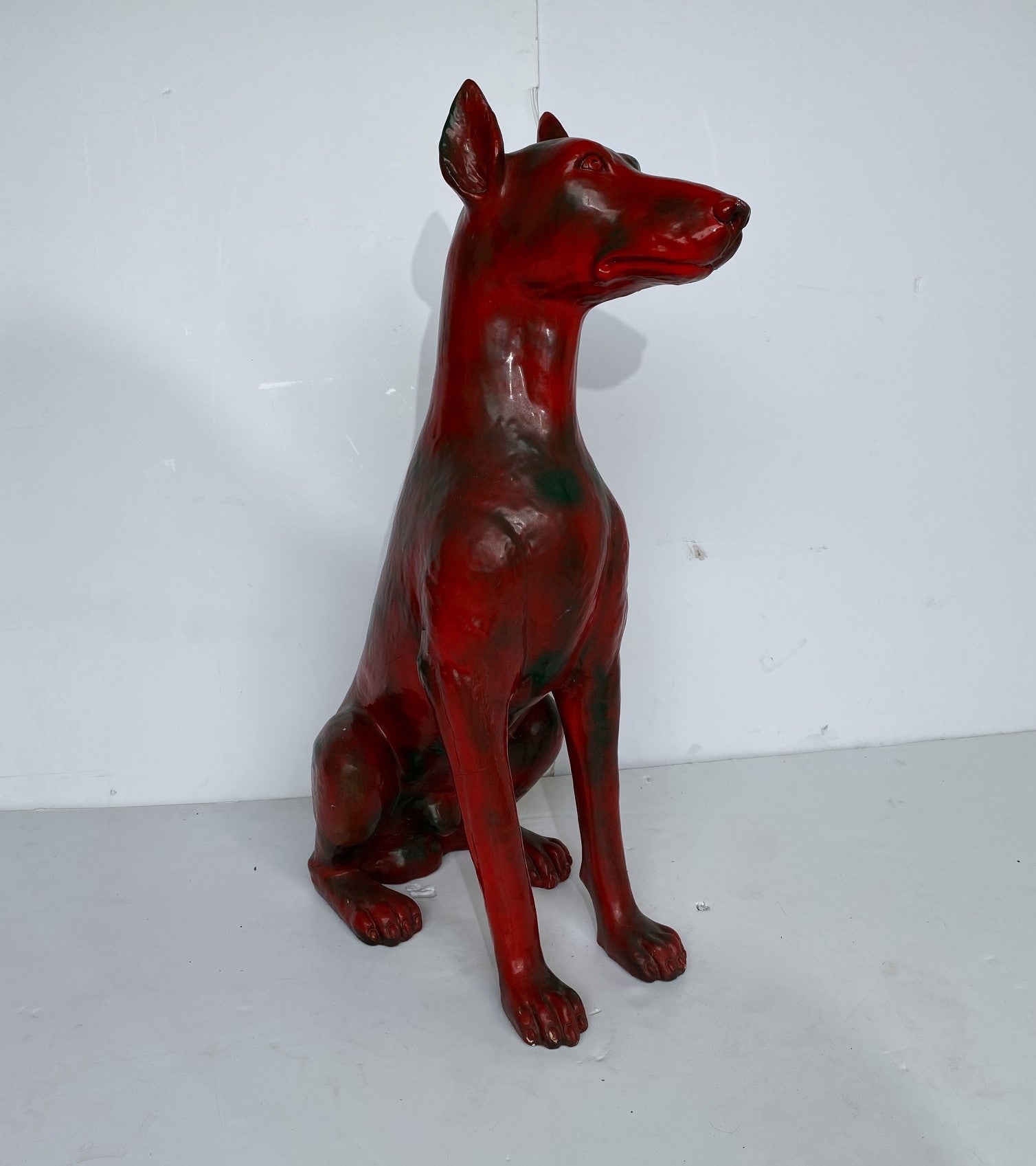 A life-size figurine of a Doberman. Signed and dated 1977.