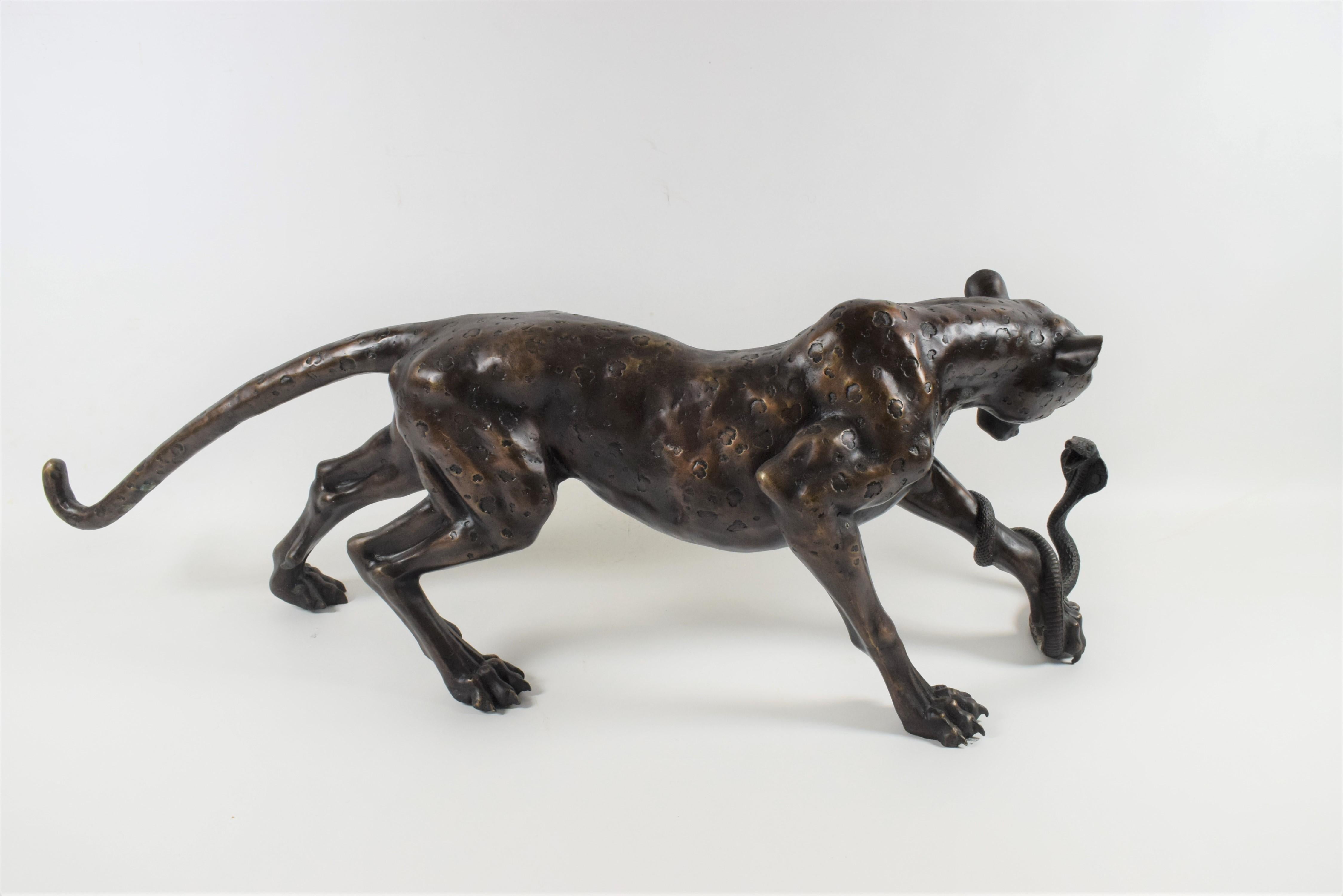 The bronze leopard pouncing on a cobra is an exquisite art deco sculpture that captures the intense and dramatic moment of a predator hunting its prey. Crafted with meticulous detail and a keen sense of motion, this sculpture brings to life the raw