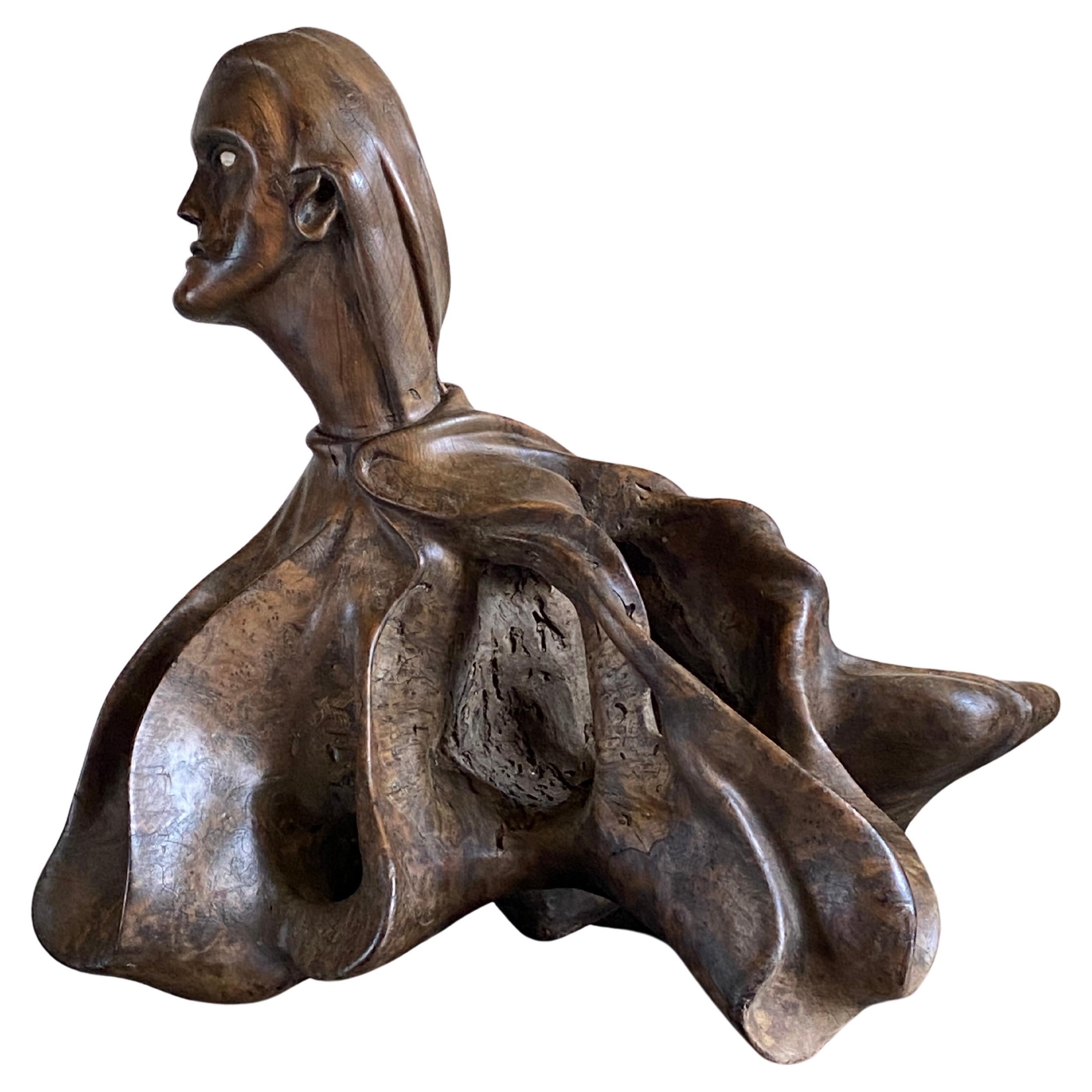 Exceptional folk art sculpture depicting a human head and body dressed in a waving organic form cloak with a bone eyepiece.

Exceptional patina with strong carved flowing lines producing a one off show piece. 



