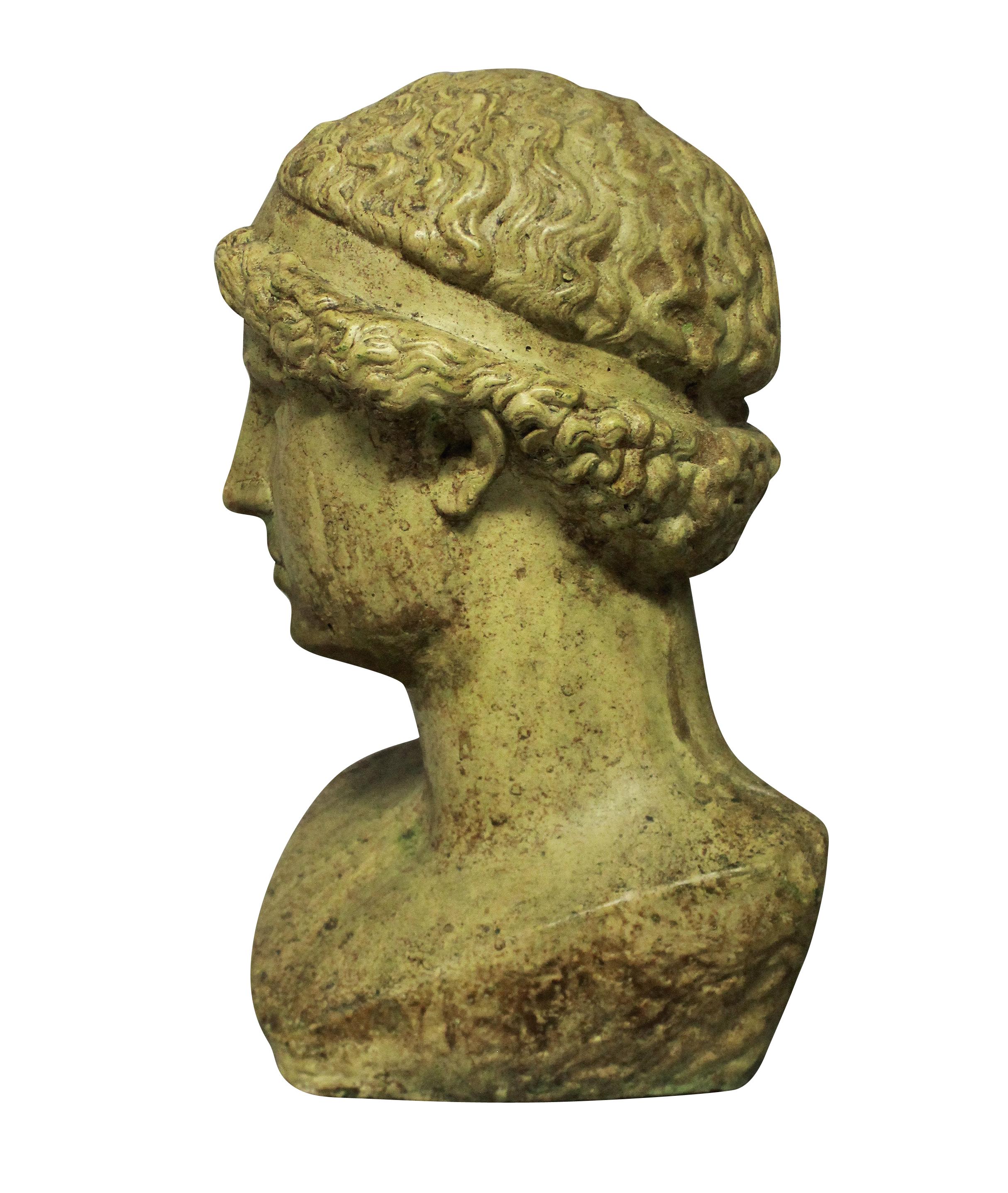 An English life-size, glazed stone head of a Hellenistic youth.