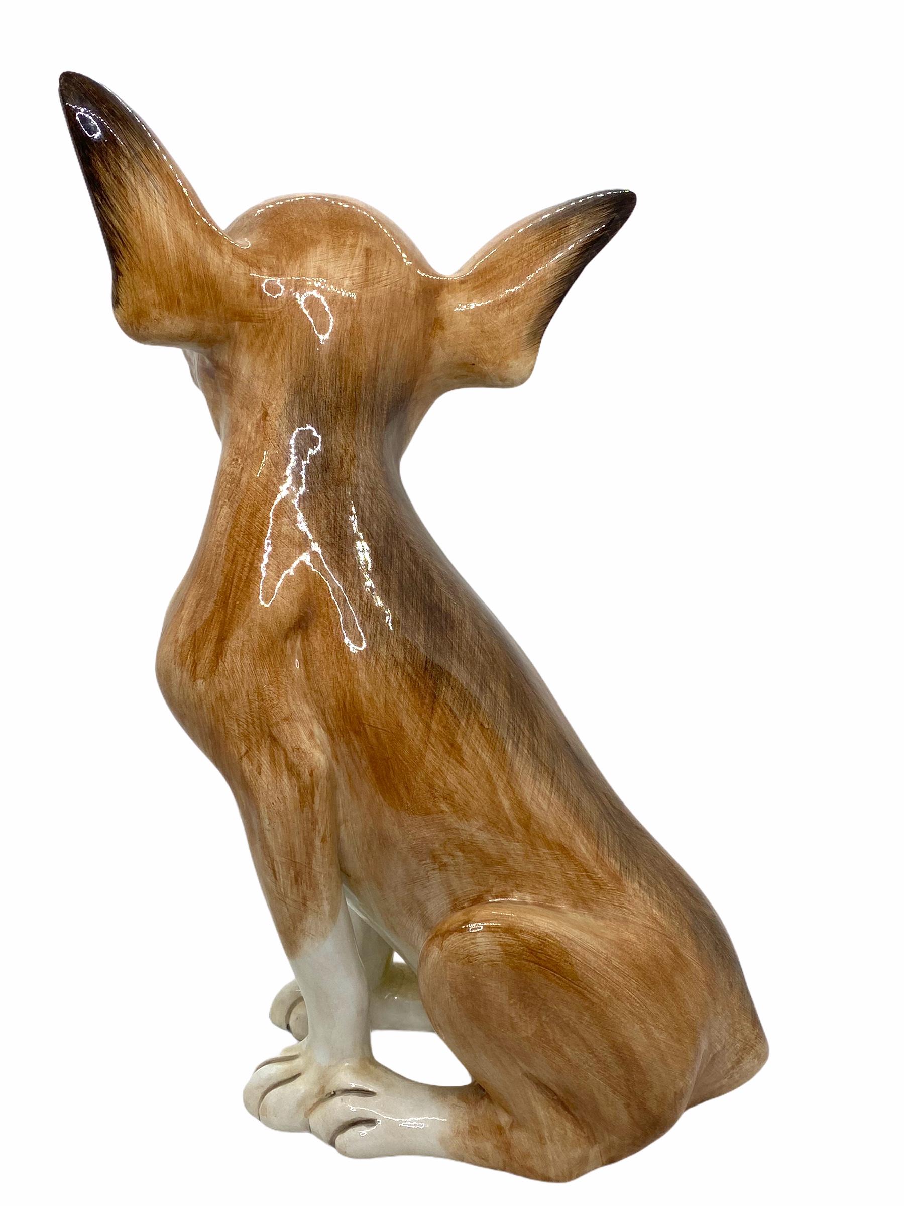 Classic early 1980s Italian Chihuahua Majolica Ceramic dog statue figurine. Nice addition to your room or entry hall. Made of majolica ceramic, hand painted. Signed on the ground. Left ear with small little chips, but this is old-age.