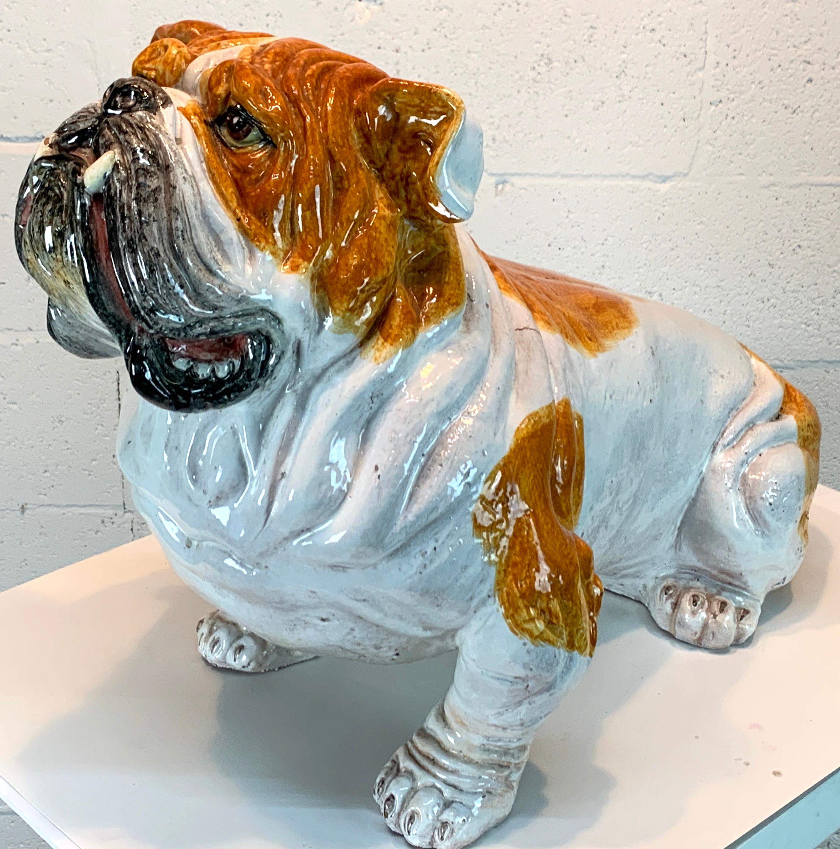 Life-size Italian Majolica bull dog, realistically modeled and hand painted, great face, a large and impressive work. Signed 'Italy' in black script. 
The pooch measures 28 inches wide x 15 inches deep x 18.5 inches high
The base measures 20