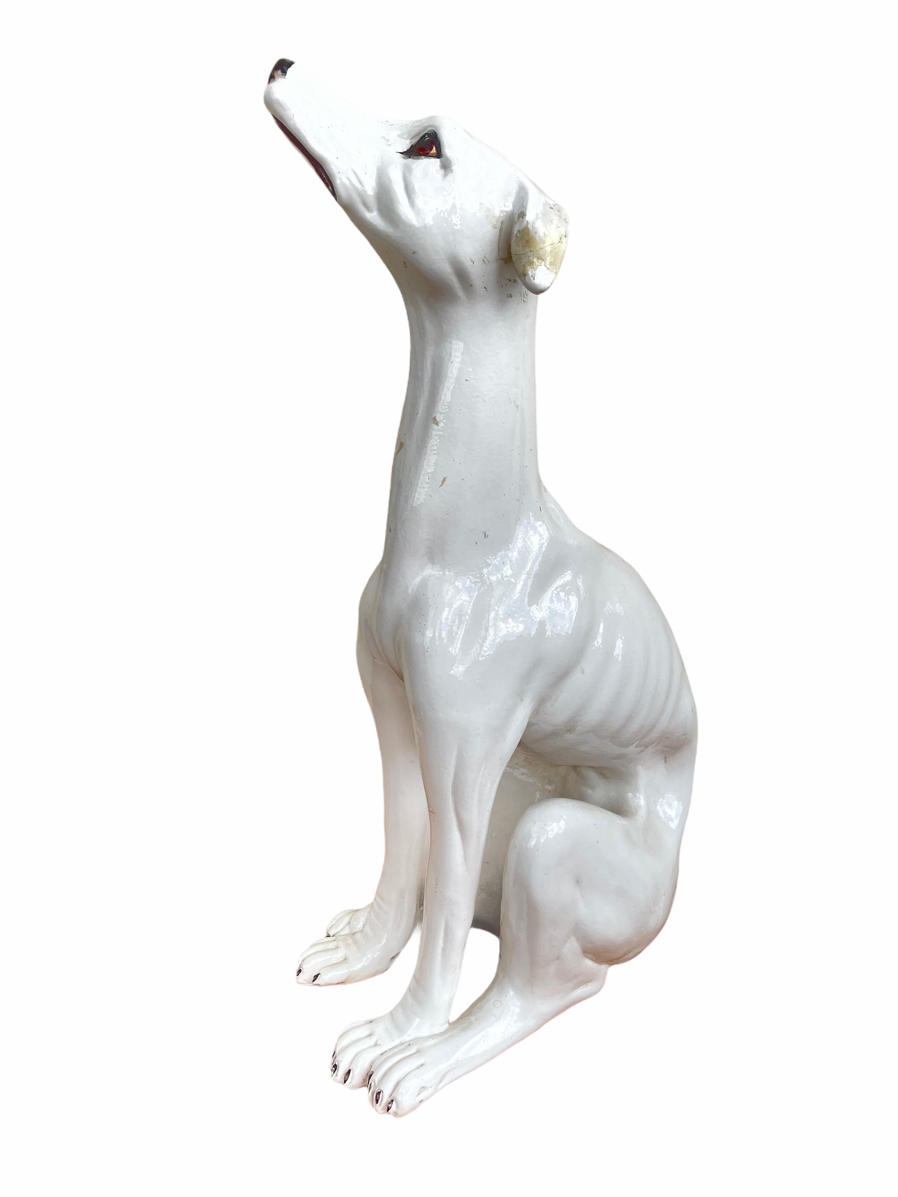 Classic early 1930s Italian Greyhound Majolica dog statue figurine. Nice addition to your room or entry hall. Made of majolica ceramic, hand painted. The left ear has been professionally restored, but this does not affect the expression and the