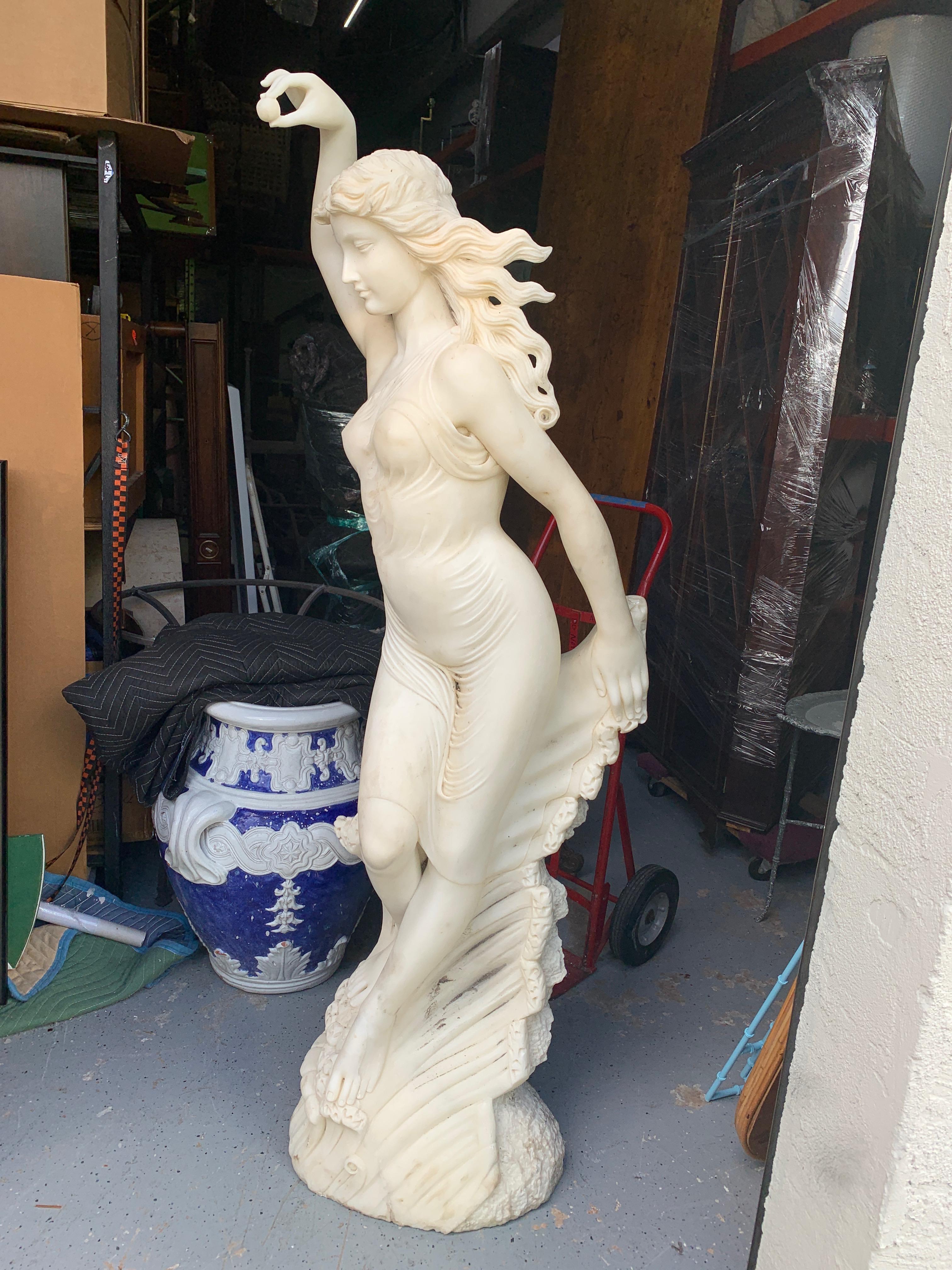 Life-size marble sculpture of Venus with Pearl, Provenance: Celine Dion
Well carved and detailed figure of Venus standing in the waves, holding a pearl, Unsigned. Ready to place inside or outside. Previously used at the pool see photo in situ. The