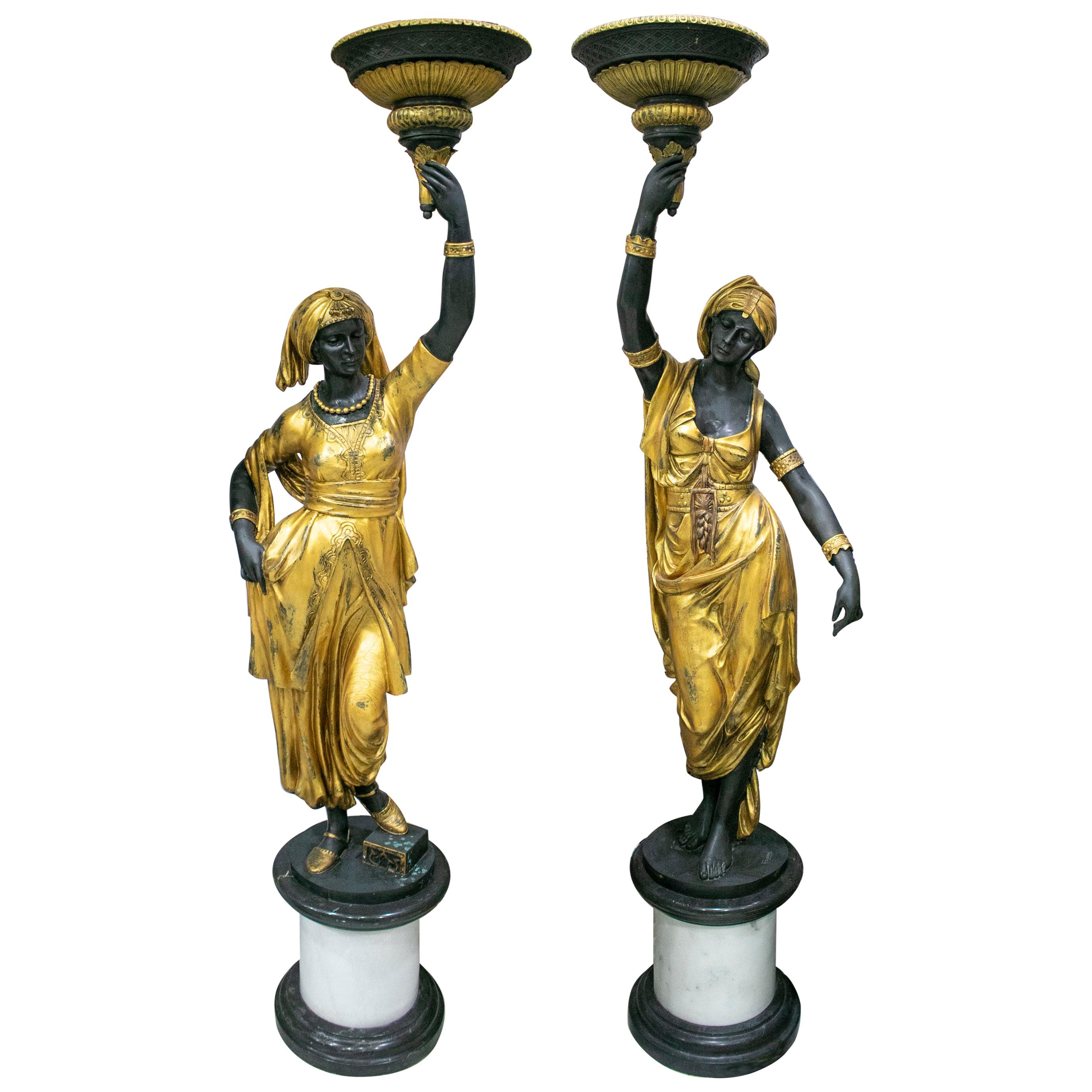 Paire de lampes torchères grandeur nature sur pied en bronze doré représentant une statue féminine, représentant une torchère