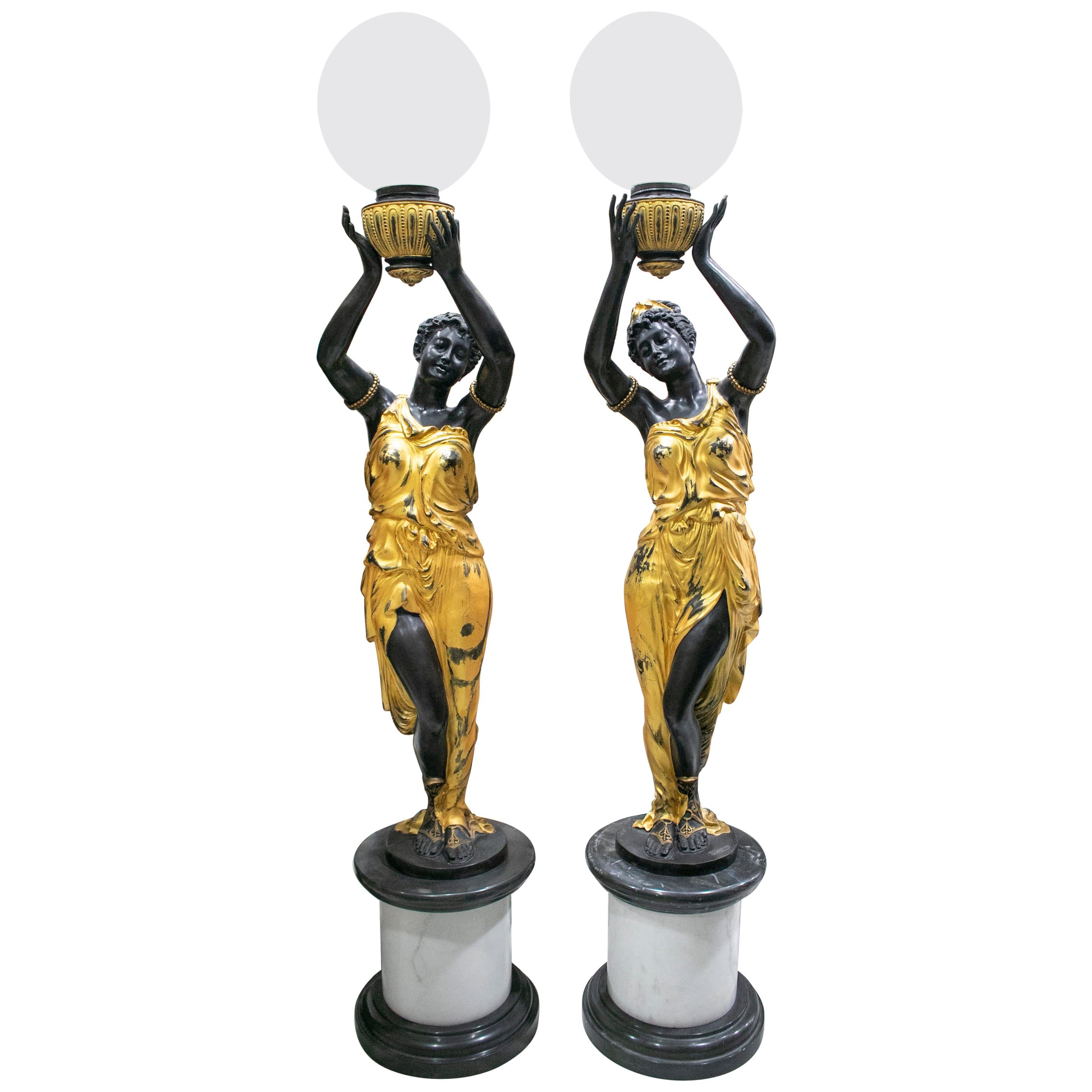 Paire de lampes torchères grandeur nature sur pied en bronze doré représentant une statue féminine, représentant une torchère