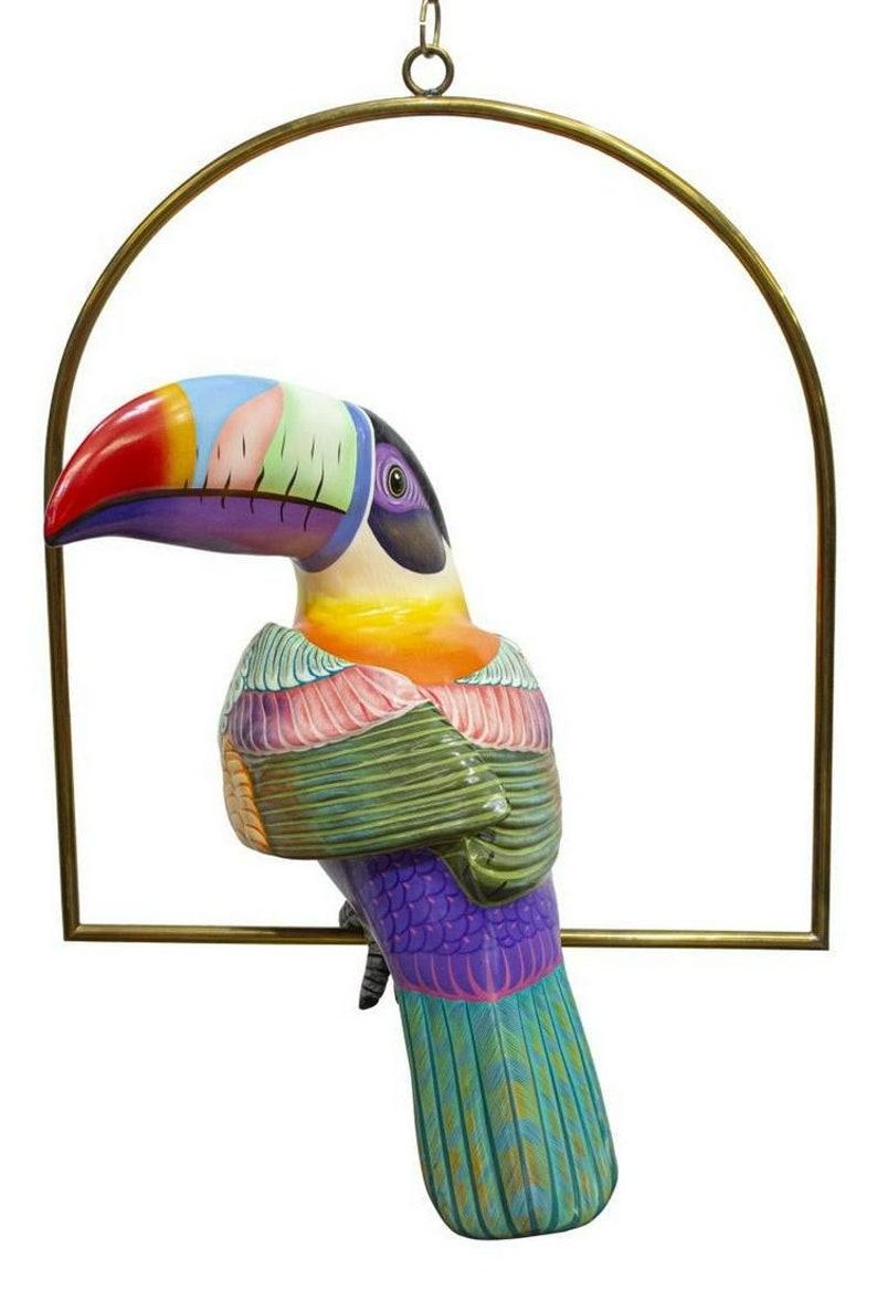 A fascinating and whimsical life size polychrome painted papier-mâché sculpture, Toucan (Parrot - Bird), signed Sergio Bustamante (Mexican, b.1942/ 1943), A.P. (artist's proof), on brass hanging perch.

Dimensions (approx):
Toucan: approx 17