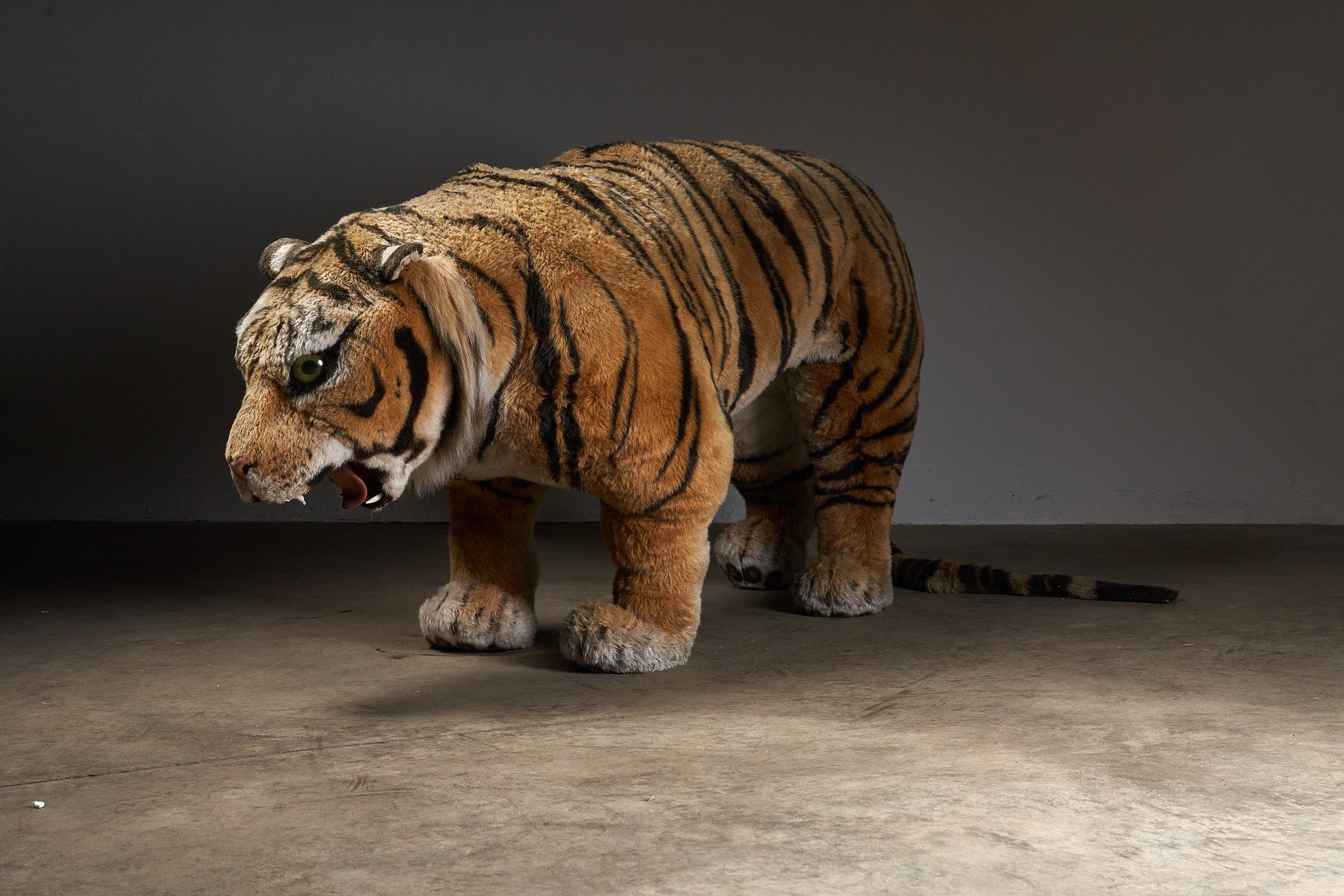 This charming and life-size tiger teddy, originally crafted as a toy for the children's room, is a testament to quality craftsmanship. Exceptionally well-made, it features an interactive element—when you sit on the back, the head playfully pops up