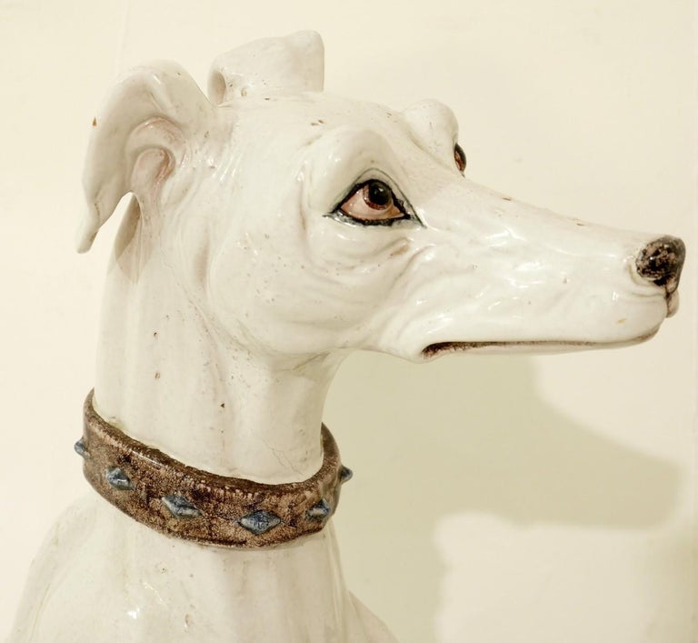 white ceramic greyhound statue