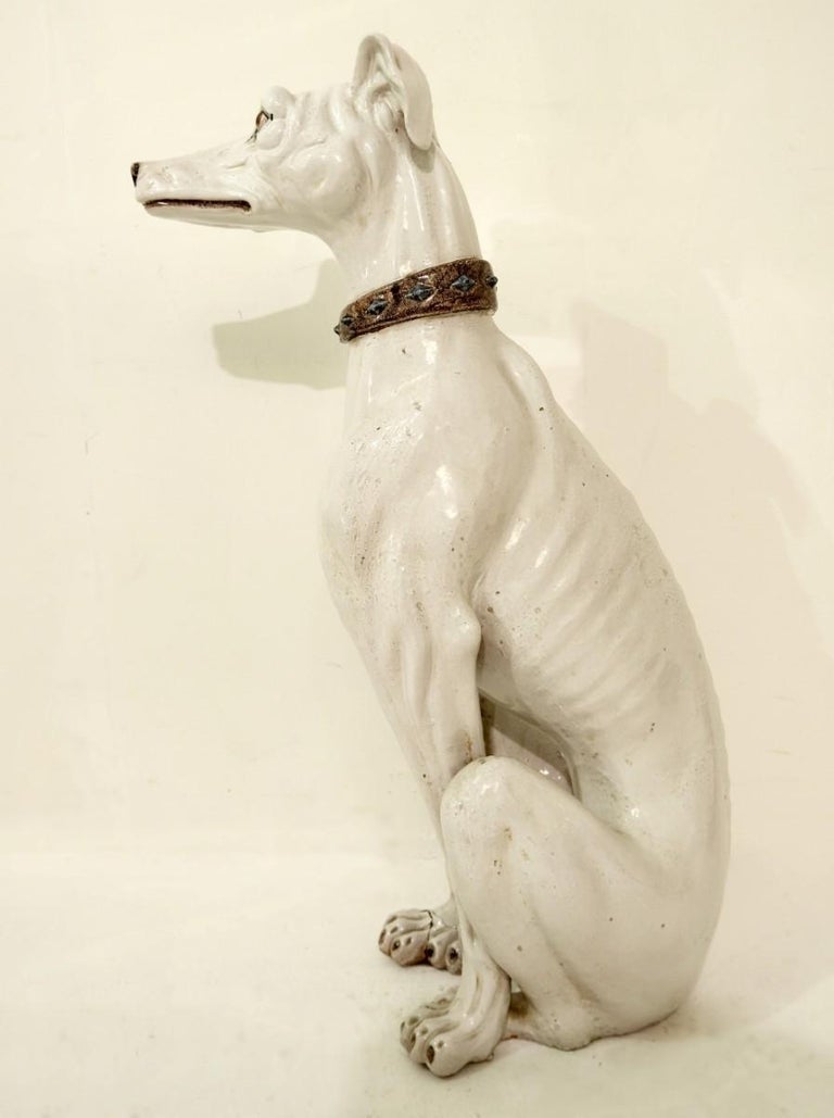 white ceramic greyhound statue