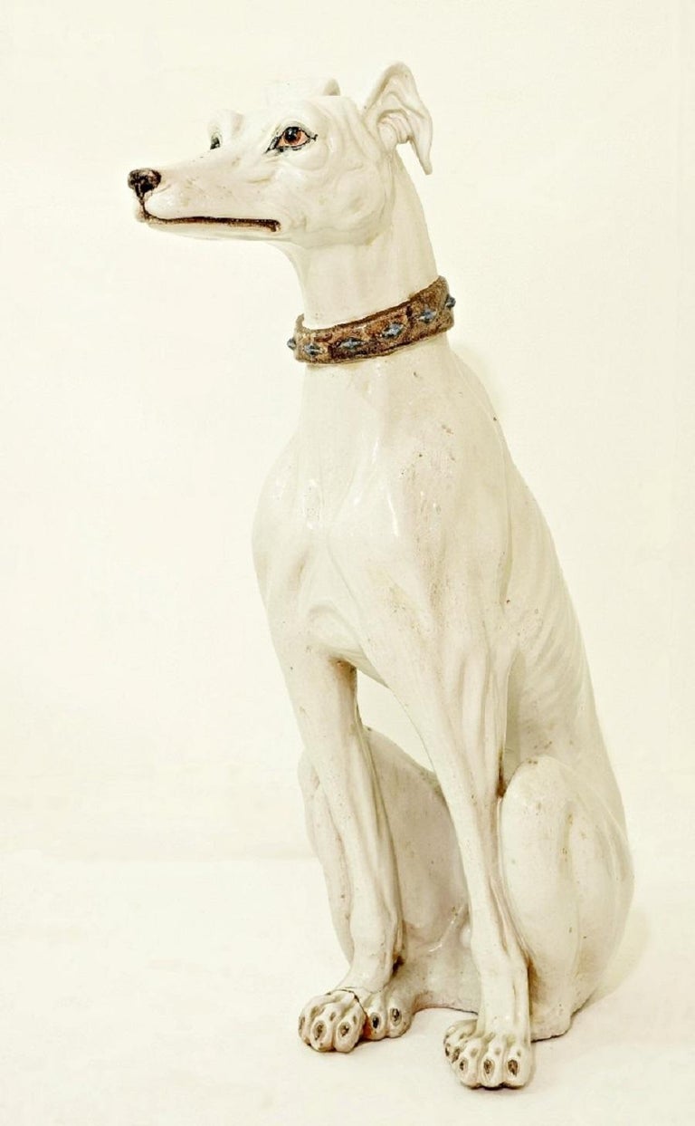white ceramic greyhound statue