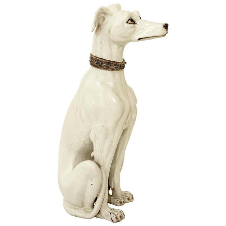 white ceramic greyhound statue