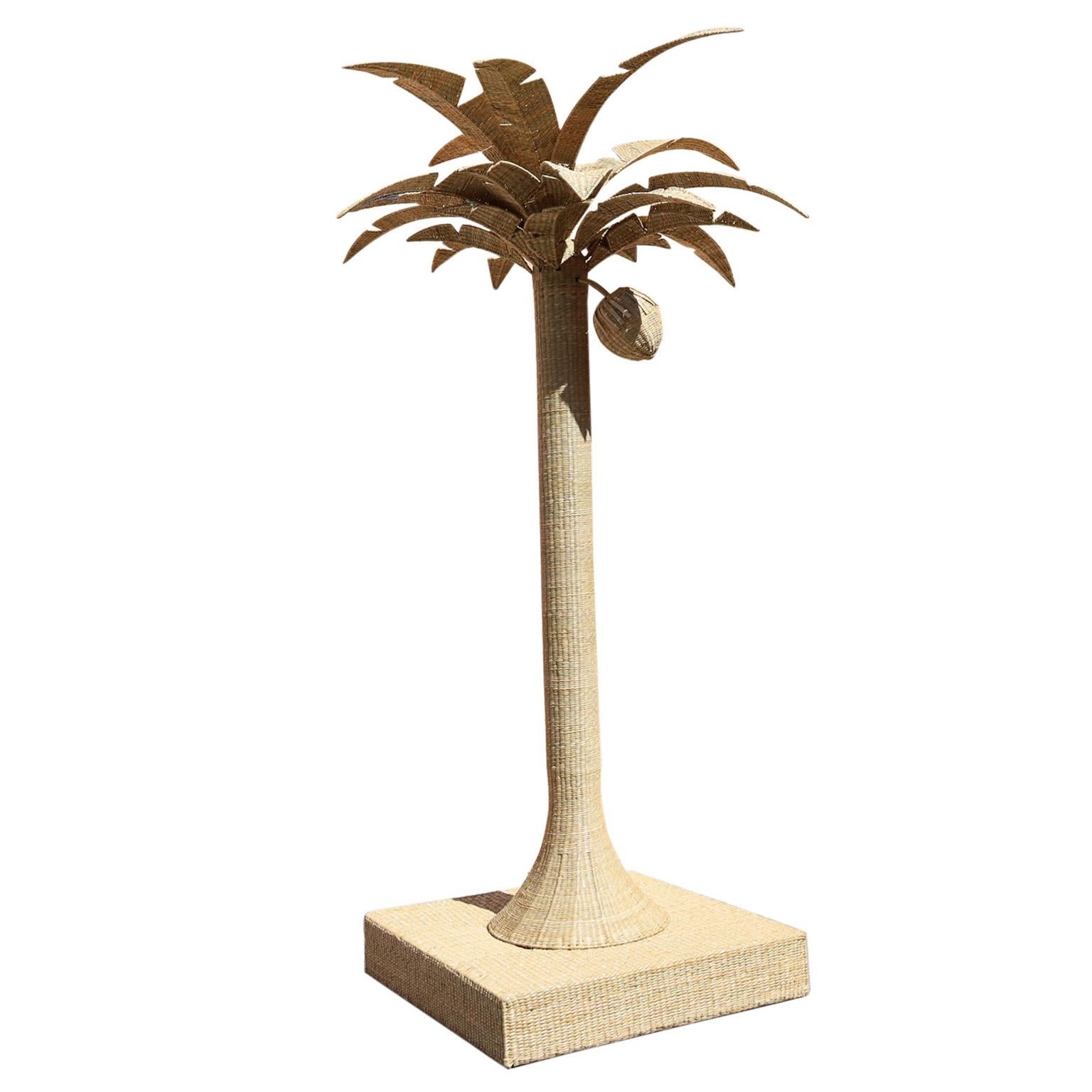 Life size sculpture of a palm tree with a coconut crafted in wicker or reed wrapped over a metal frame with impressive stylized presence. From the FS Flores Collection designed and offered exclusively by F.S. Henemader Antiques.