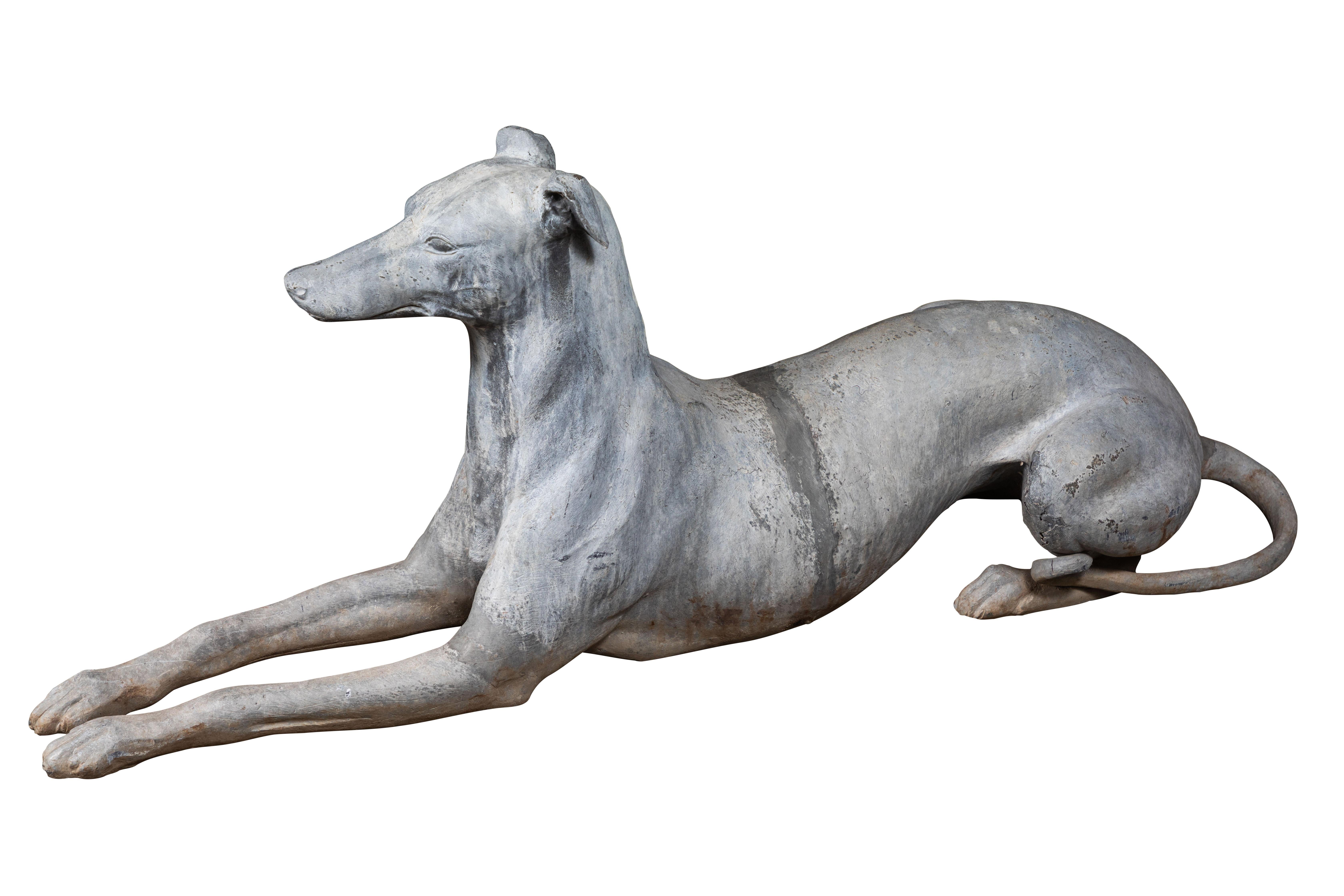 Absolutely chic pair of detailed, left and right, hand-cast, French, lead and zinc, recumbent greyhounds from the early 1900s. Exceptional patina.