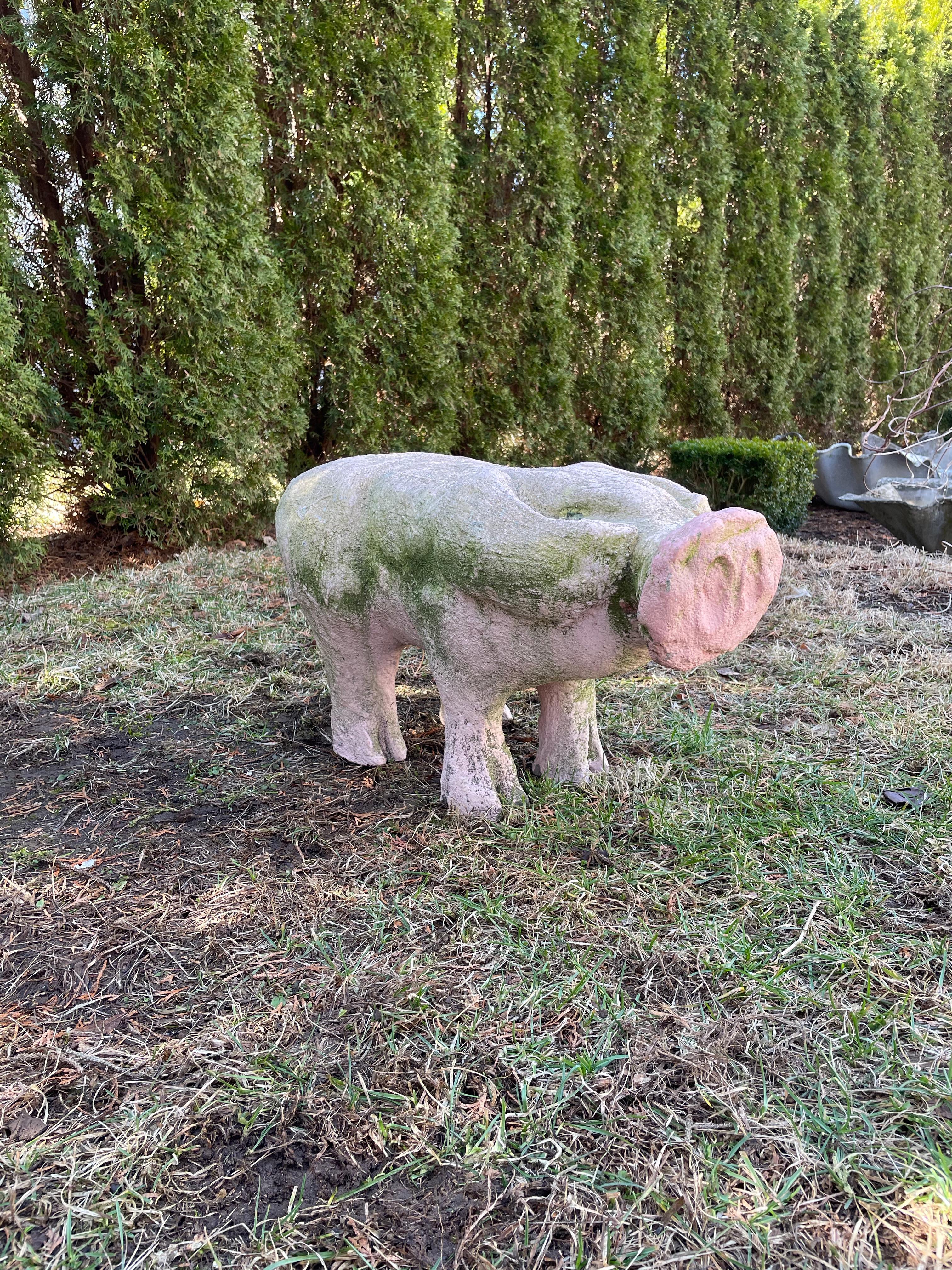 We absolutely adore this life-sized piglet in its original pink paint with lots of greening. Rare in form and size, it has cloven hooves, an oversized snout and a tightly-sprung tail. Heavy and made of cast stone, it can remain outside year-round if