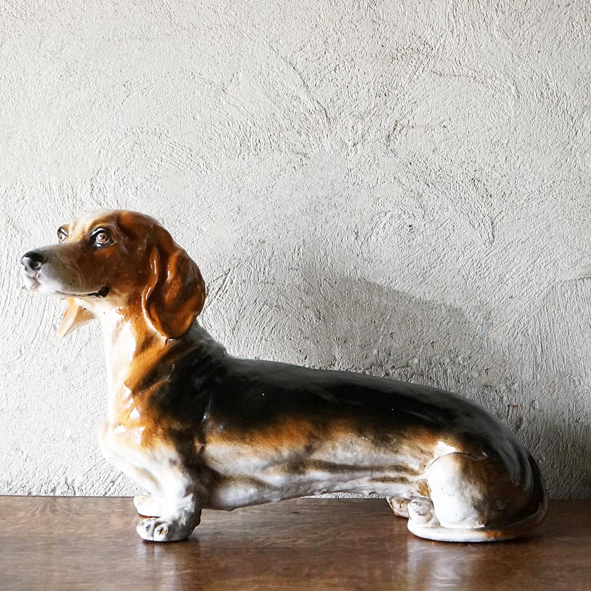 Mid-century sausage dog statue. Black, tan and white piebald coat glazed pottery doggy. Modelled with a lovely cheeky little face! Excellent quality unsigned but stamped ‘Made in Italy’ on his paws. Overall he is in good vintage condition, there is
