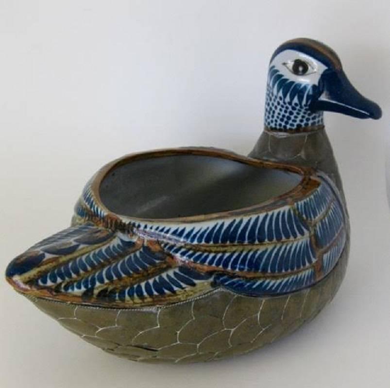 Life-sized mallard duck planter by Palomar of Tonala, Mexico. The ceramic pottery duck is hand-painted in beautiful deep, dark blues and browns, and is covered in brass feathers. Planter opening measures 6 1/2